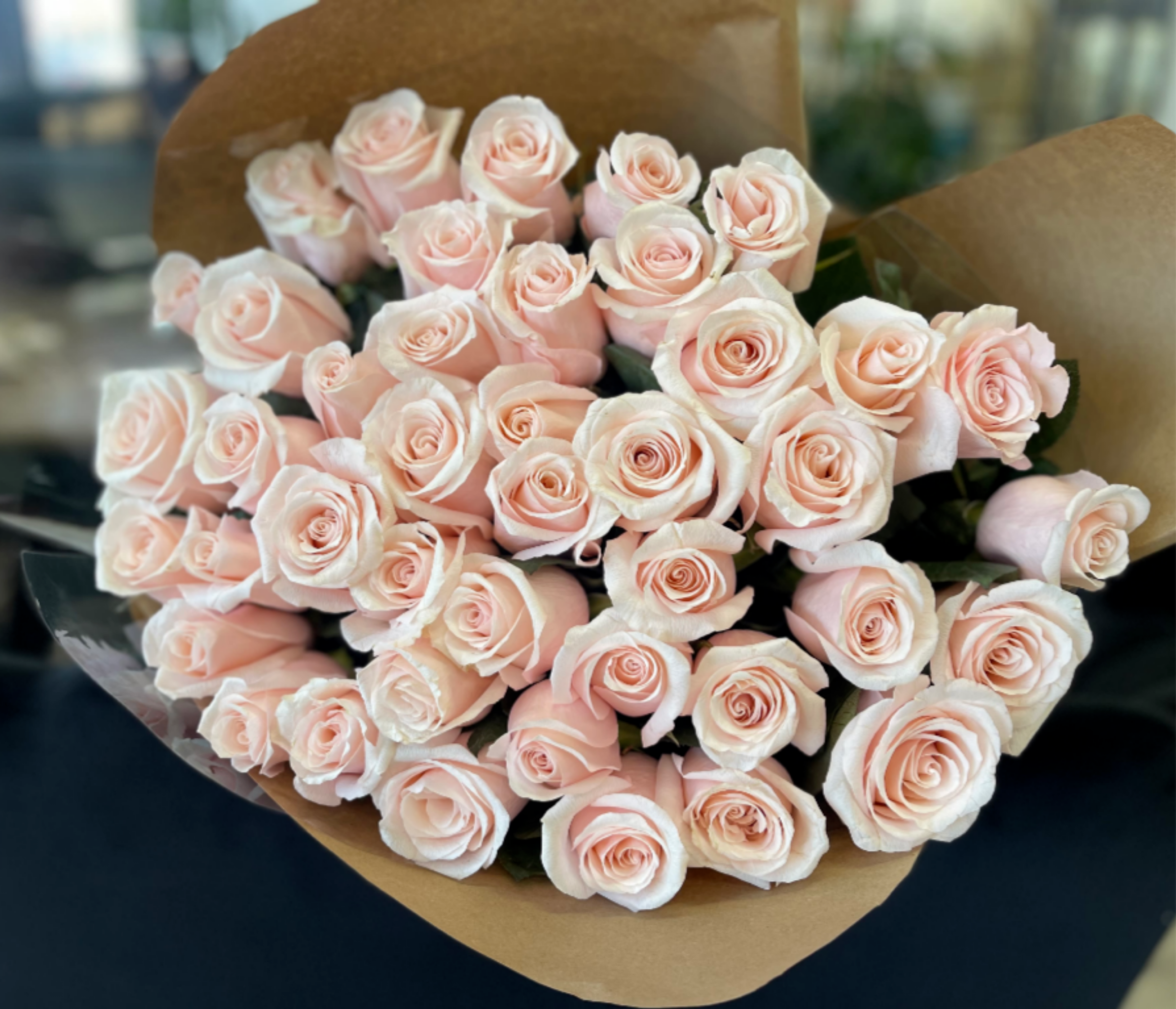50 Blush Pink Roses Bouquet - A beautiful bouquet of premium 50 blush pink roses, finished with a perfectly matching satin bow for a refined, elegant look. This romantic arrangement is perfect for Valentine’s Day, anniversaries, or special occasions. Wrapping Upgrade: For an additional $10, the bouquet can be wrapped in premium wrapping paper.       Some florals are seasonal, if a particular flower will not be available due to season, we will substitute for similar flower, composition, color pallet and value of the arrangements as closely as possible. All effort to create a floral arrangement as close to the photo shown, the actual arrangement may vary slightly in its appearance from the photo shown. If you have any questions about your order, we welcome you to call us in or email    Holiday Delivery:  Same-day delivery available. Deliveries are made throughout the day based on routing.