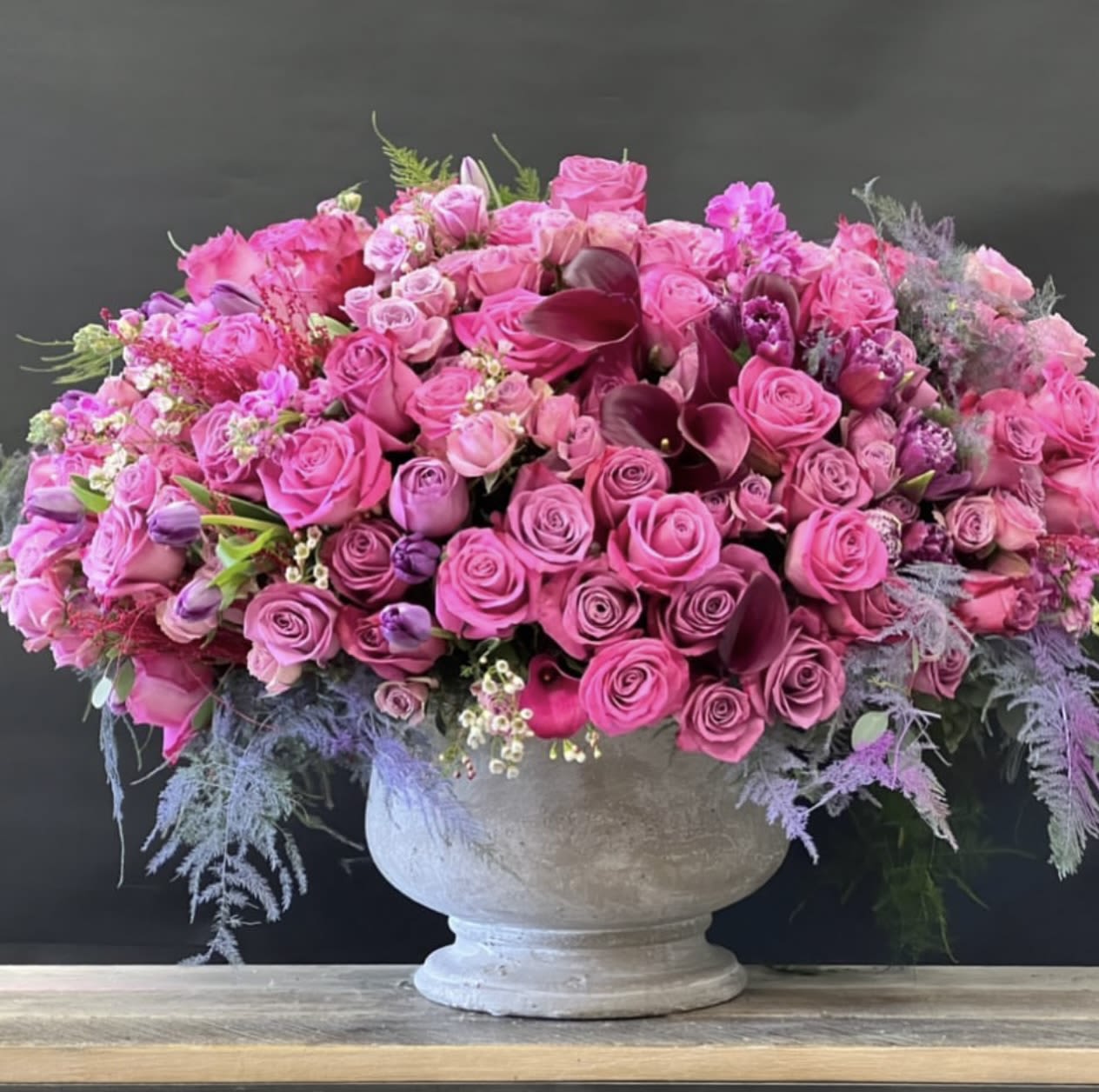 Color Burst Pink Mix Arrangements  - A lush burst of vibrant blooms, this masterpiece composition is designed to captivate. Featuring the designer’s selection of fuchsia and hot pink flowers paired with rich striking calla lilies, it creates a bold statement with timeless beauty. Presented in a refined stone ceramic vase, this striking arrangement is perfect for any occasion.   Some florals are seasonal, if particular flower will not be available due to season, we will substitute for similar flower, composition, color pallet and value of the arrangements as closely as possible. All effort to create a floral arrangement as close to the photo shown, the actual arrangement may vary slightly in its appearance from the photo shown. If you have any questions about your order, we welcome you to call us in or email   Holiday Delivery:  Same-day delivery available. Deliveries are made throughout the day based on routing. 