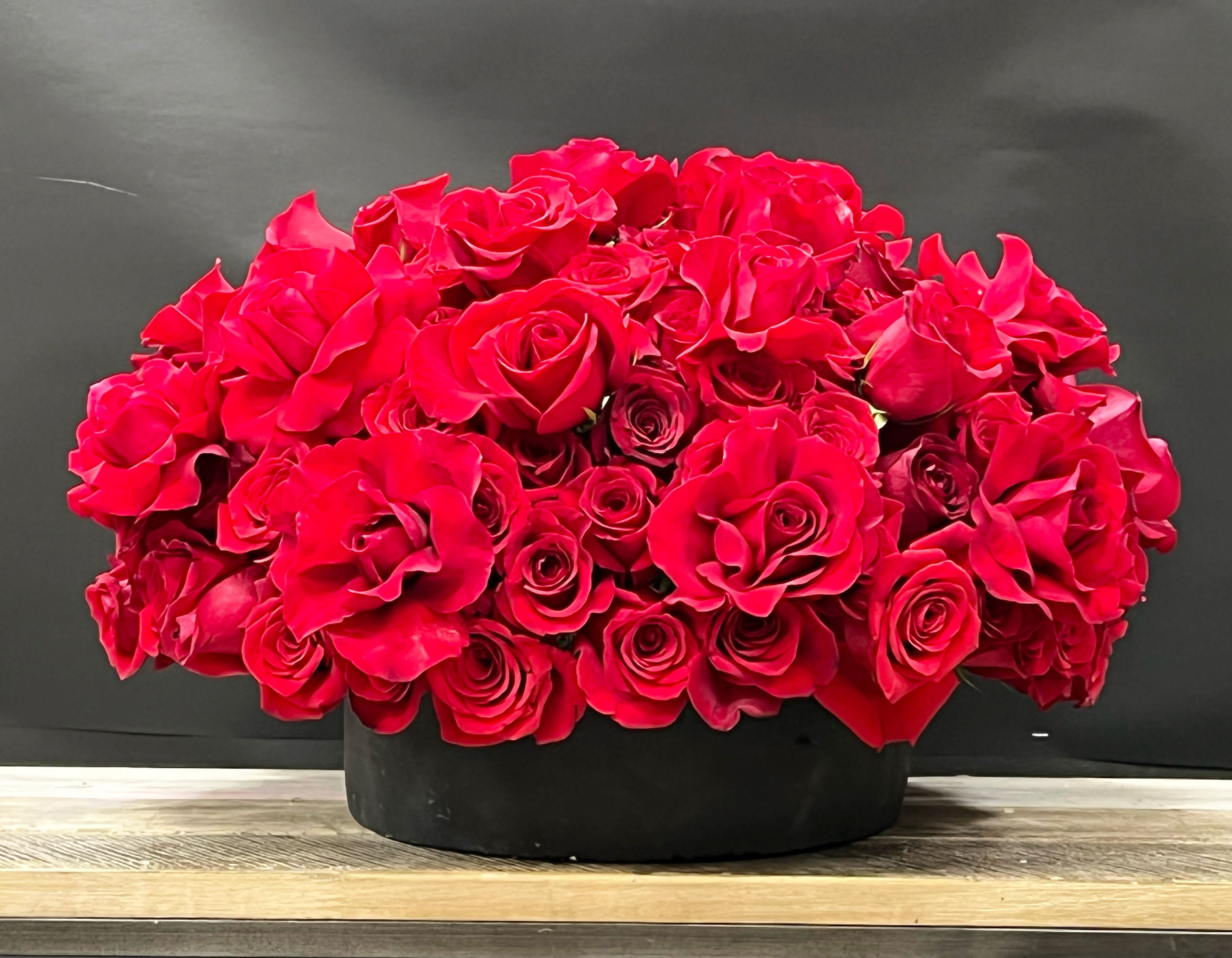 Luxury Red Rose Arrangement - Hand-arranged red rose designs, gift-ready and perfect Valentine’s surprises. Limited availability on Valentine’s Day — order early.  A luxurious dome of premium red roses arranged in a sleek black box for a bold, romantic statement. Perfect for anniversaries, Valentine’s Day, and special occasions, this classic red rose arrangement delivers timeless elegance and unforgettable impact.     Some florals are seasonal, if a particular flower will not be available due to season, we will substitute for similar flower, composition, color pallet and value of the arrangements as closely as possible. All effort to create a floral arrangement as close to the photo shown, the actual arrangement may vary slightly in its appearance from the photo shown. If you have any questions about your order, we welcome you to call us in or email    Holiday Delivery:  Same-day delivery available. Deliveries are made throughout the day based on routing.