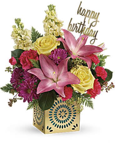 Birthday arrangement with pink lilies, yellow roses and mixed blooms in a gold cube container