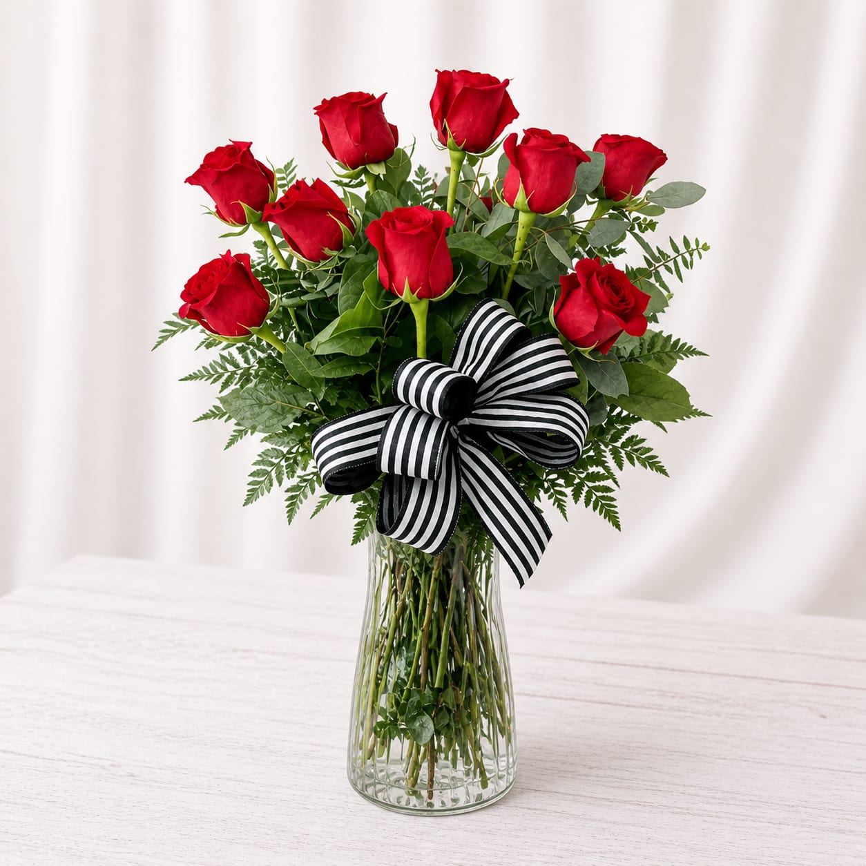 Long Stem Dozen Roses - A more modern spin on roses - this includes mixed greenery and no filler flowers. Curly willow and a classic black and white bow! Upgrade to 1.5 or 2 dozen!