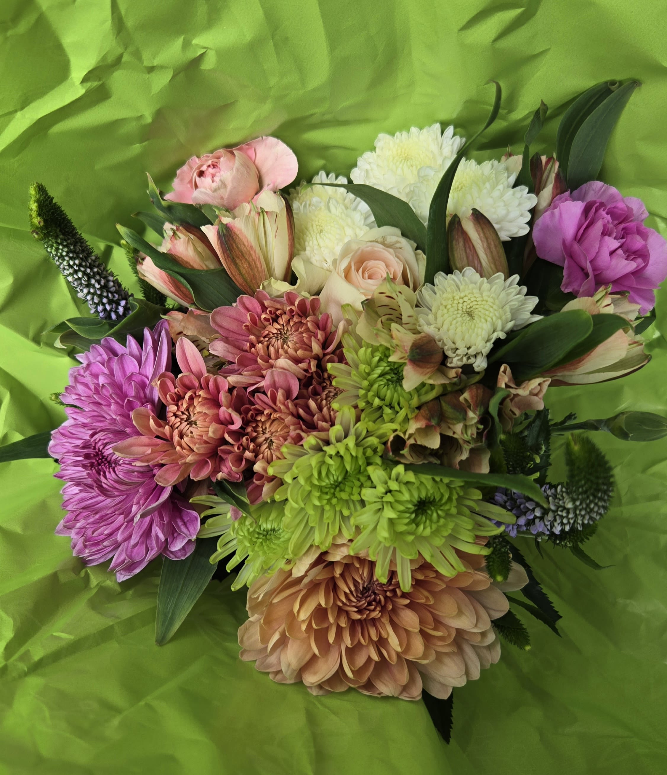  My Mom - What might bring a nice smile to someone special, like your mom, mother in-law, wife, grandmother or sister, maybe a great friend. This variety of flowers would be designed in a simple glass vase with a bow! Limited Availability for this holiday week and thereafter. We have additional flowers and vases available for backup designing. Great for any occasion, too! Not a large luxurious size design for "standard" Choose "Premium" for larger size with additional flowers.  