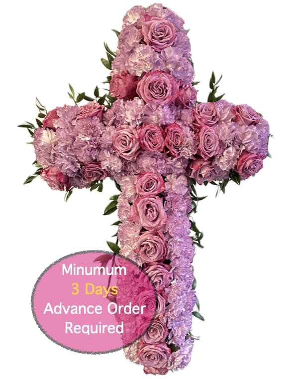 Cross-shaped floral arrangement of pink and lavender roses and carnations