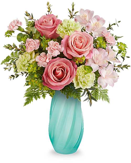 Pink roses and pale flowers arranged in a turquoise vase