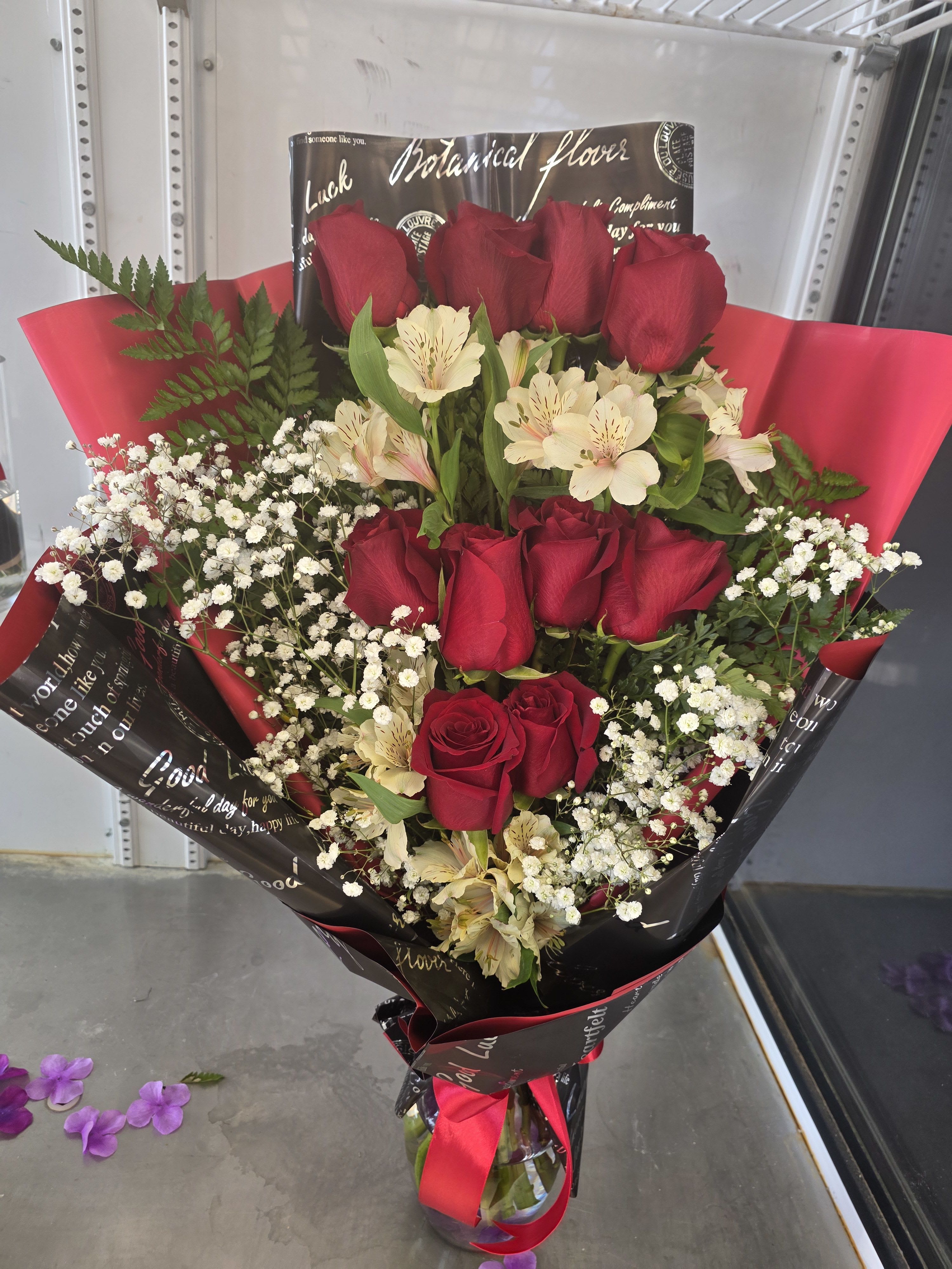 Bouquet of red roses and white alstroemeria in black and red wrap