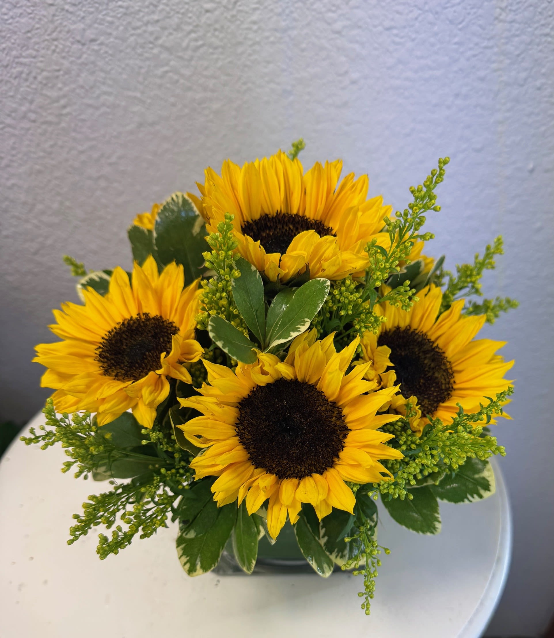 Ray of Sunshine Bouquet - Whether it's raining or the sun is shining our Ray of Sunshine Bouquet will brighten the day for any occasion. Featuring our beautiful sunflowers expertly arranged in a clear glass cube.