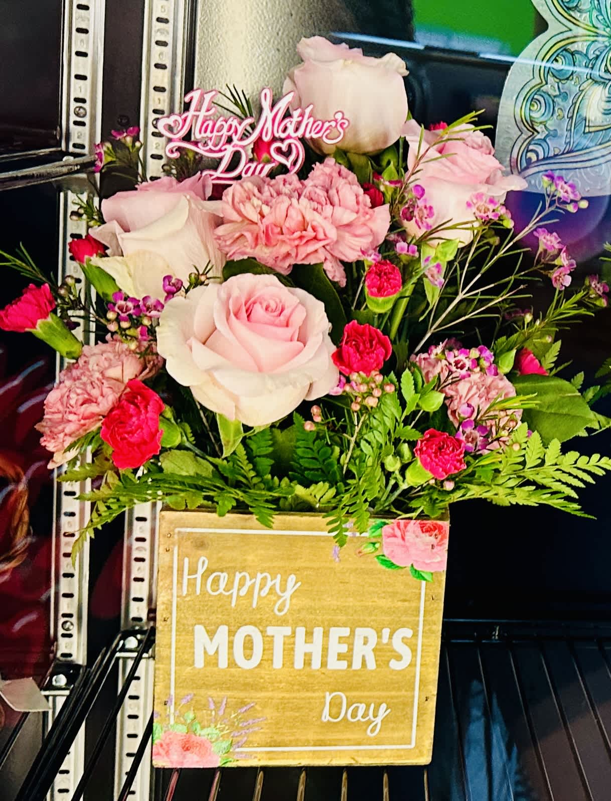 The “Mom-nificent” - A magnificent Mother’s Day Designer’s Choice Arrangement* displayed in a keepsake container. Perfect for gifting, our “Mom-nificent” is a heartfelt way to say “thank you” this Mother’s Day.  *Style/Color Varies From Photo