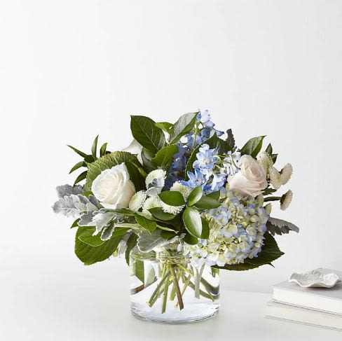 Clear Skies Flower  -  Pet Friendly? No . Delphinium can be toxic to cats and dogs. Keep out of reach; avoid homes with curious cats.   Human Allergy Note No major allergy-triggering flowers noted.   Care &amp; Longevity Trim stems and refresh water every 2–3 days. Keep out of direct sunlight and away from heat or vents. Remove fading blooms promptly. Maintain gentle misting for greenery if needed.   Best Occasions &amp; Situations  Congratulations  Birthday  Anniversary  Get Well ‍ Graduation  Boss’s Day  Just Because ‍ Mother’s Day  Why Customers Love It Bright, calming color palette Airy, elegant arrangement ideal for any room Handcrafted and gift-ready Fresh, premium blooms Versatile for multiple happy occasions