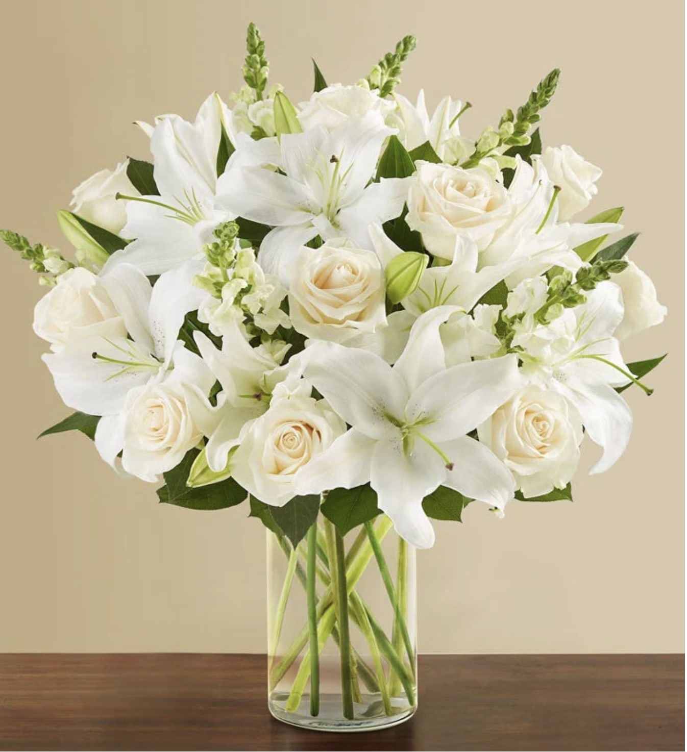 Classic White Arrangement - Liles, Snapdragons , roses and more in a glass Cylinder vase.  Pictured is the Premium