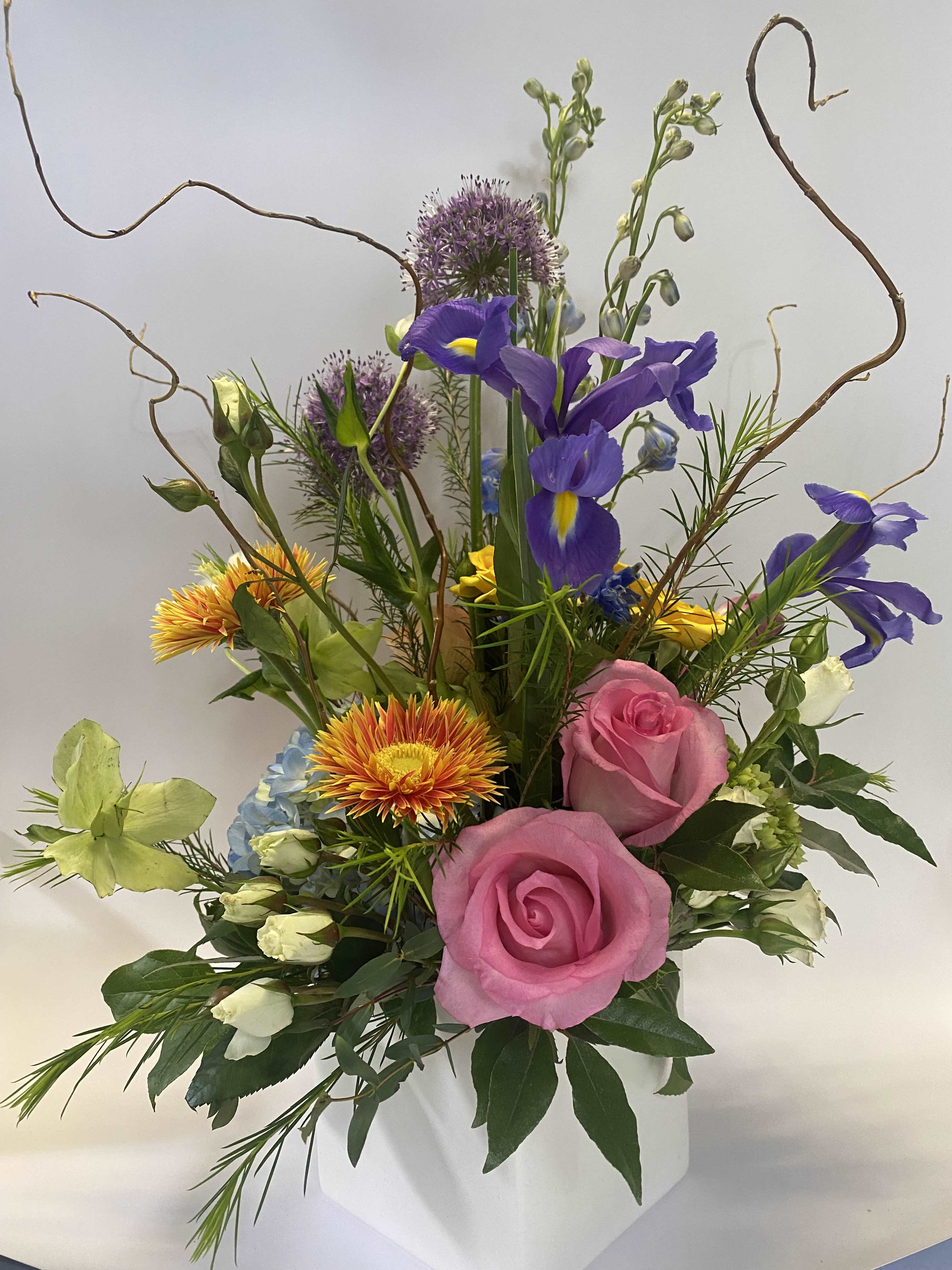 Best and Brightest - A Burst of Colorful Joy Bring fun, vibrancy, and energy to any occasion with our 'Best and Brightest' arrangement! Designed to dazzle, this bouquet features a playful mix of premium blooms in punchy, cheerful colors that are sure to brighten anyone’s day. **Fresh and Fun Blooms: Includes florals such as roses, tulips, hydrangeas, irises, curly willow, hellebores, delphinium, allium, and gerberas, creating a lively and dynamic display. **Seasonal Substitutions: While we strive to include all listed flowers, seasonal substitutions may occur to ensure the freshest and most beautiful arrangement. **Unique Design: This outside-the-box arrangement is crafted to stand out, making it the perfect gift for someone who loves bold, colorful, and joyful surprises. Whether it’s a birthday, celebration, or just because, the 'Best and Brightest' bouquet is guaranteed to bring smiles and spread happiness. Let this radiant arrangement light up someone’s day with its vibrant charm!