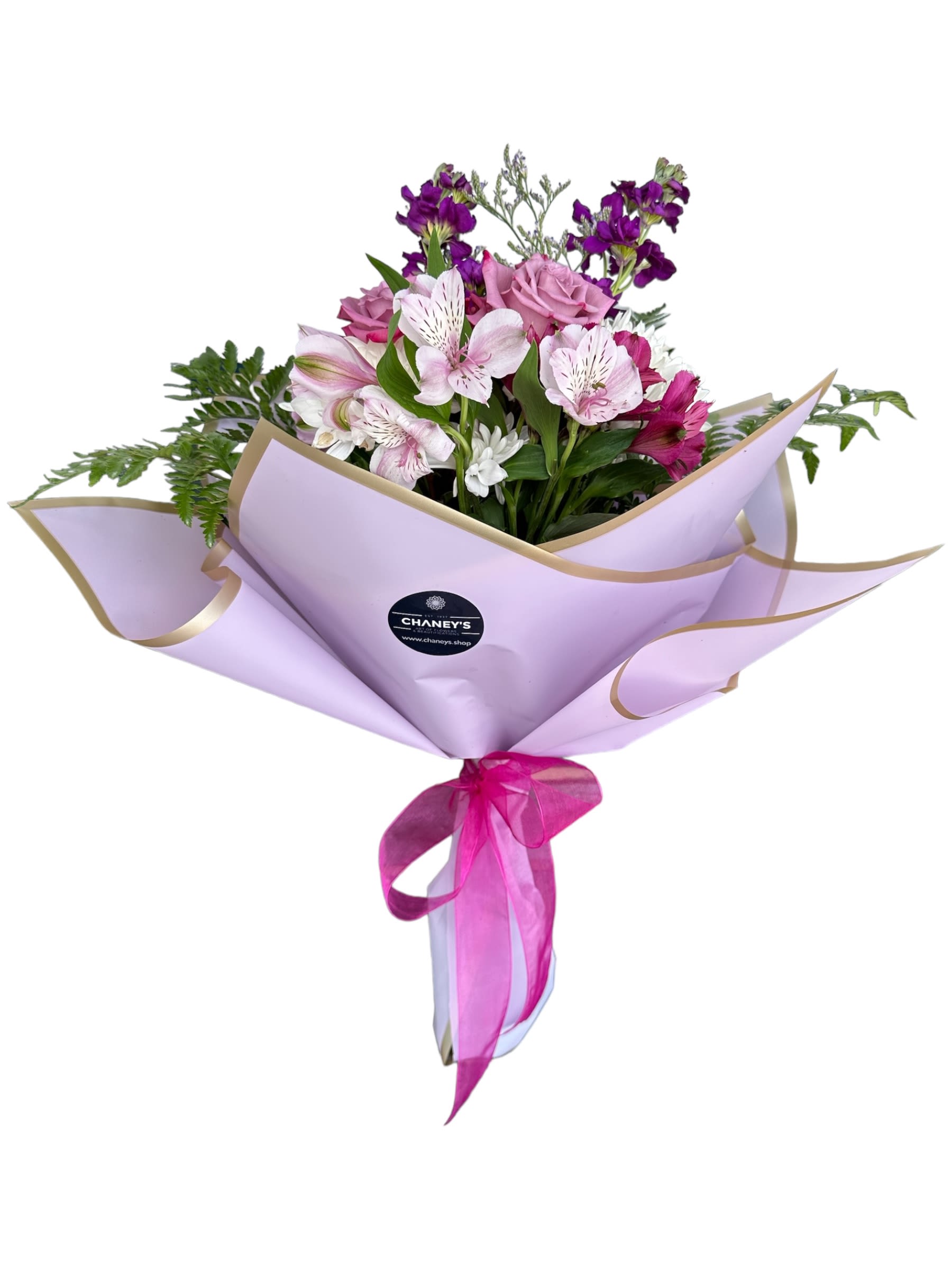Bouquet of pink and purple flowers wrapped in lavender paper with a ribbon