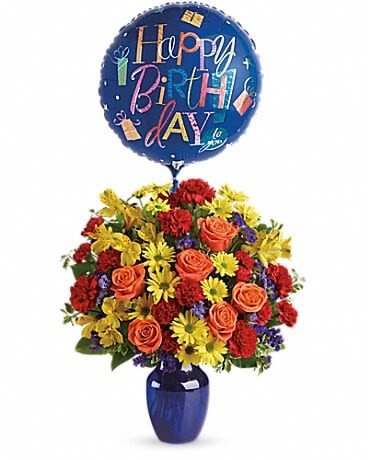 Birthday balloon above a colorful flower arrangement in a blue vase