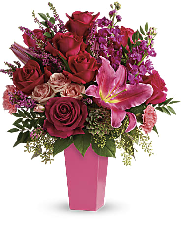 Pink and red rose bouquet in a tall pink vase