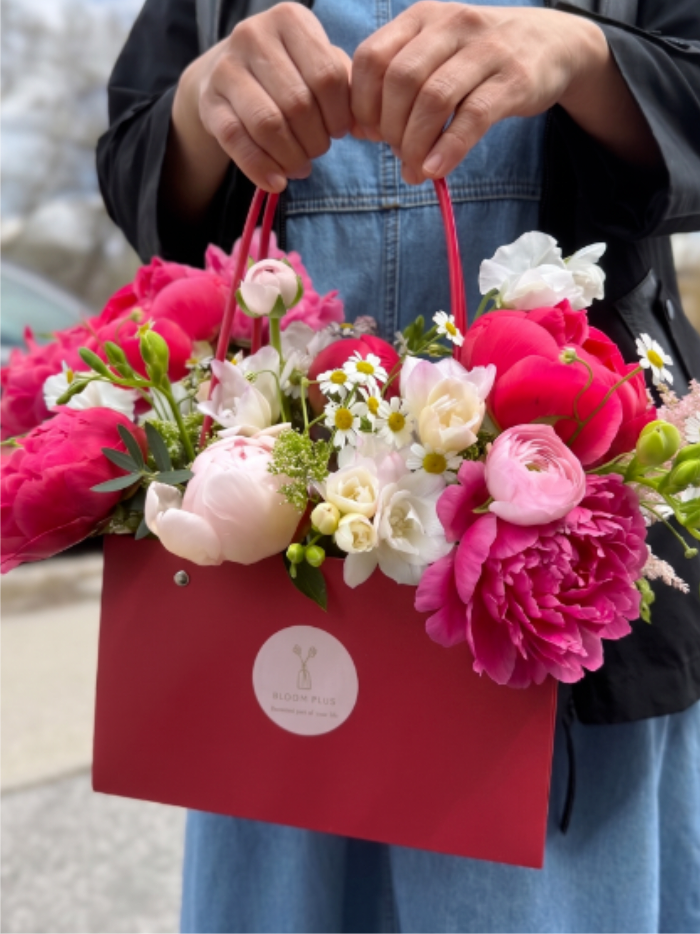 BP120 - Coral &amp; Light Pink Mixed Arrangement - Hand-tied mix of coral peonies, blush ranunculus and white daisies in a red gift bag. 