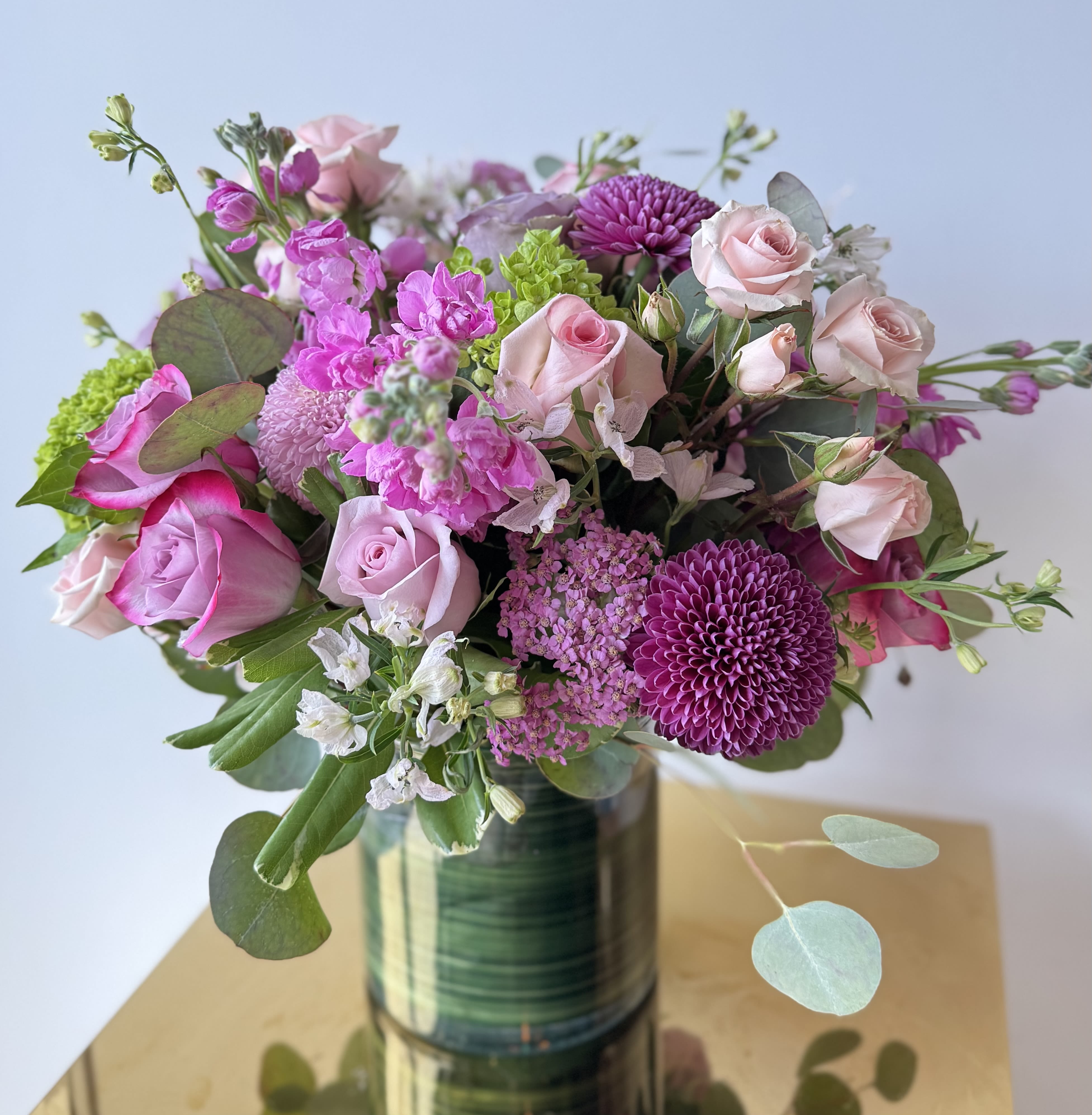 Blush &amp; Lavender Serenity - Delight someone special with this elegant arrangement of fresh blush, lavender, and peach roses, accented with soft lilac stock, vibrant mums, and lush greenery. Hand-tied with satin ribbons and presented in a modern glass vase, this bouquet is perfect for birthdays, anniversaries, sympathy or simply to say "I'm thinking of you."  image showing premium size