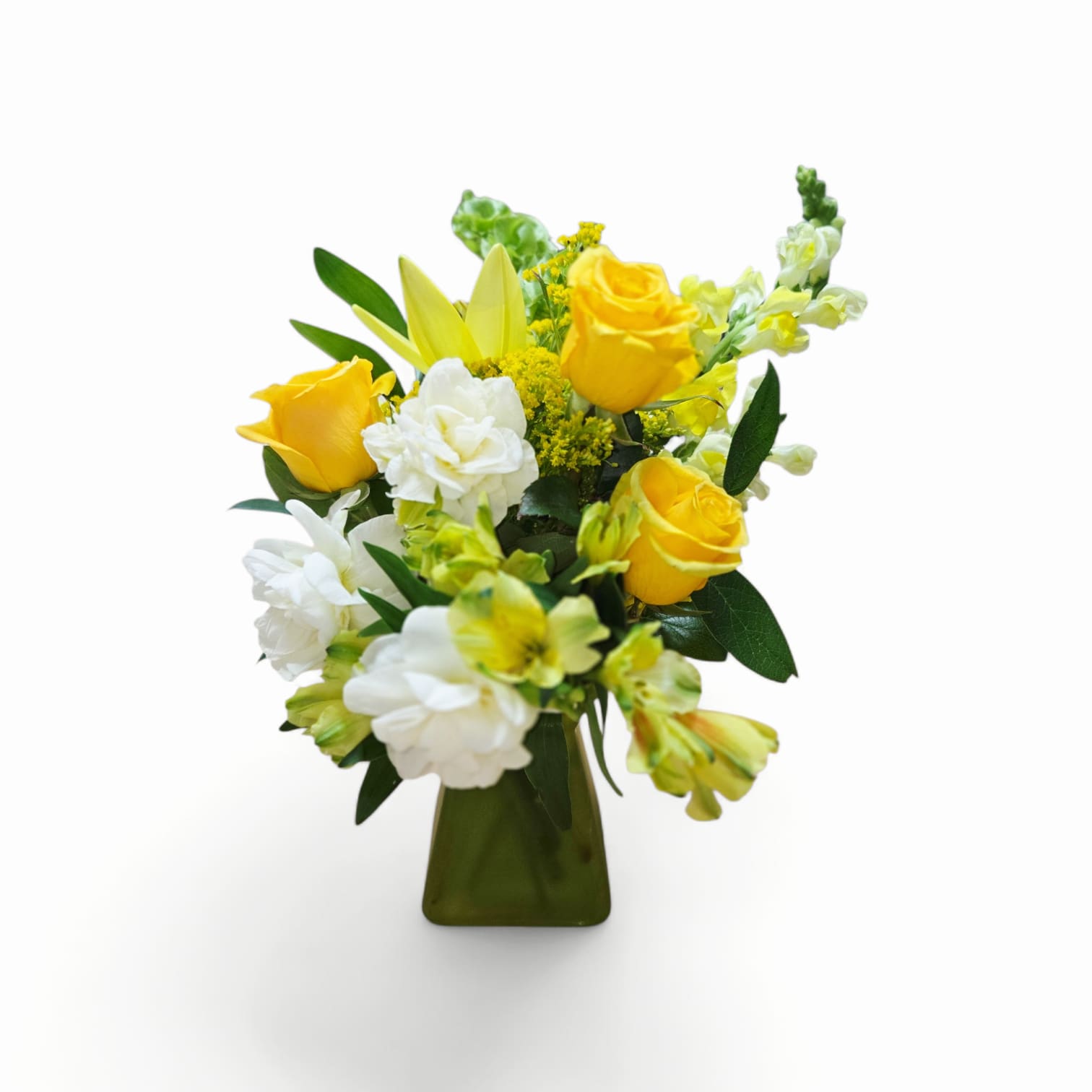 Smile Sunshine - Sunlit yellow roses take center stage in this Mom yellow flower arrangement, a cheerful bouquet perfect as a birthday bouquet, Mother's Day gift, or "just because" surprise to lift her spirits. The bright yellow and crisp white palette reads joyful and optimistic-she'll feel genuinely celebrated the moment these blooms arrive.  A compact upright design blends yellow roses, sunny carnations, pale yellow-green snapdragons, and white alstroemeria for layered texture and clustered visual interest. The flowers are arranged tightly for a full, garden-fresh look and sit in a dark green glass vase that lends a contemporary, polished finish to the display. The mix of soft petals and vertical snapdragons creates both softness and structure, making this arrangement ideal for a kitchen table, desk, or bedside.  Thoughtfully suited for moms, friends, or colleagues who enjoy bright, uplifting color, this arrangement arrives ready to display-no extra arranging needed. To keep blooms looking their best, refresh the water every couple of days and trim stems slightly when you change the water; the compact vase size makes it an easy, everyday centerpiece that keeps the mood sunny.