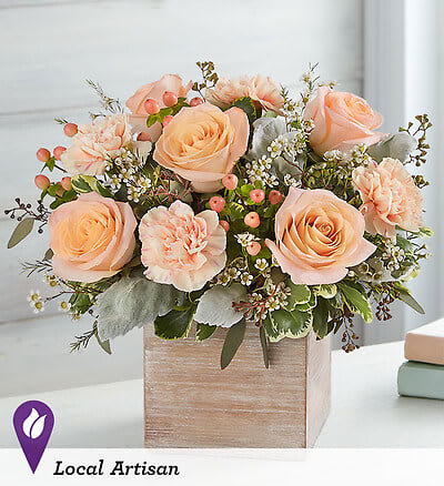 Peach roses and carnations in a wooden box arrangement