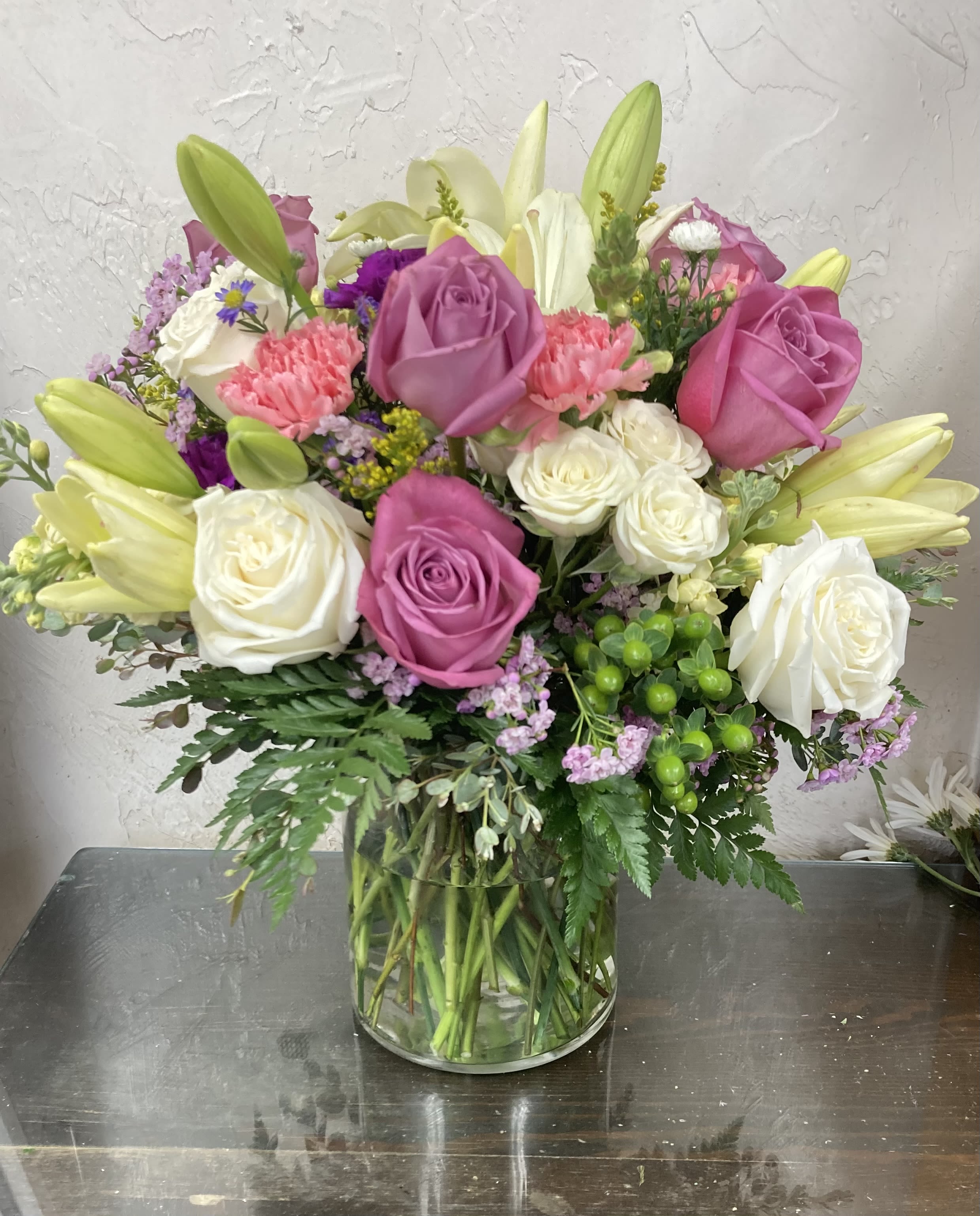 Floral Fantasy - Show her she is extra special with an Extra Large Oversized vase with an abundant number of flowers, about twice as many flowers compared to s standard arrangement. Includes Roses, Carnations, Daisies, Lilies, Spray Roses, Filler flowers and greens .  **Just let us know if you have a favorite color and we will try to have that be your dominate color.**