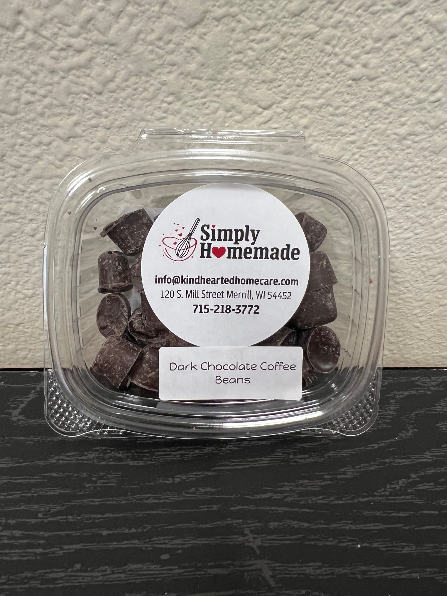 Plastic container of dark chocolate coffee beans