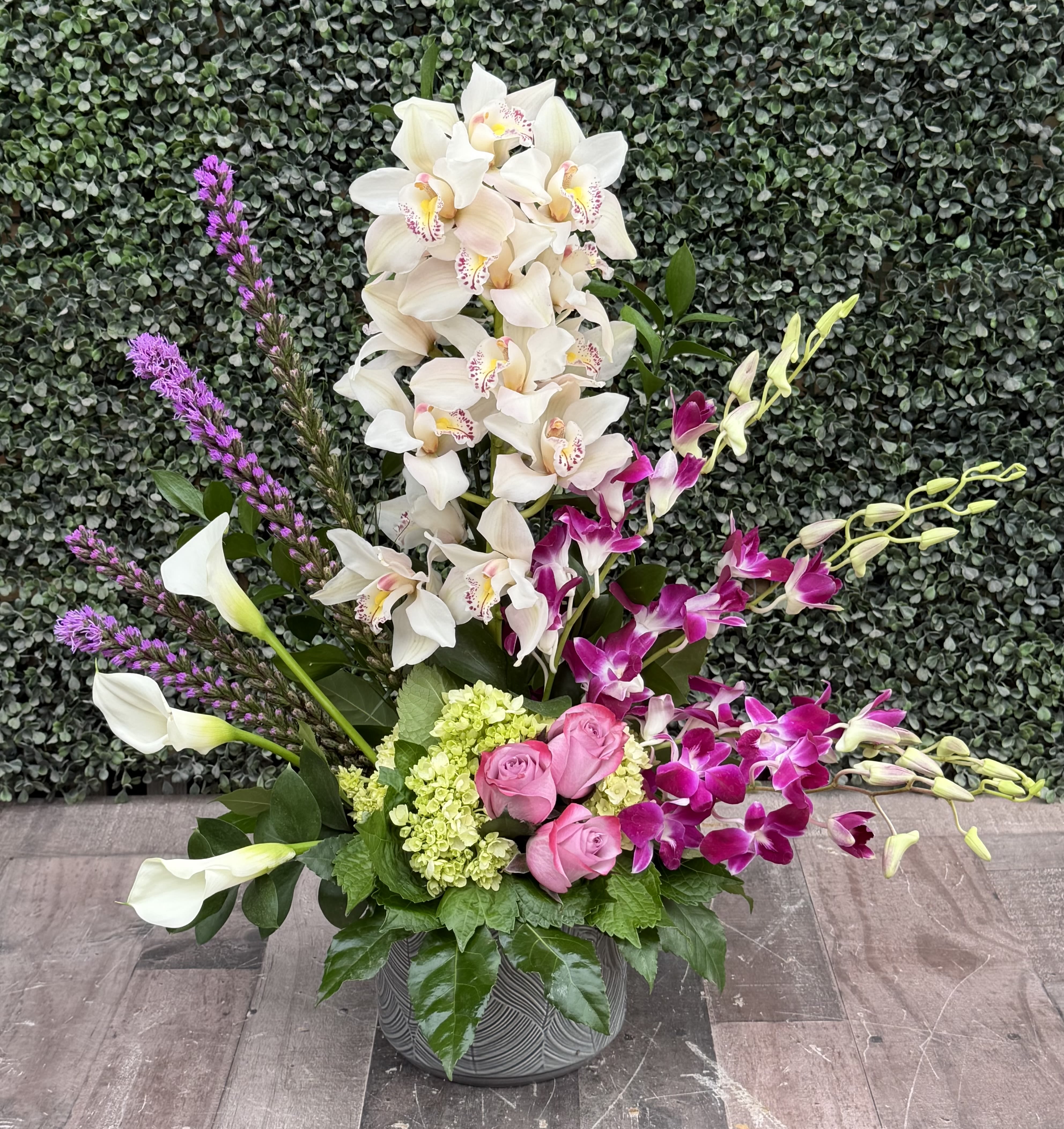 Purple Passion - A lovely mix of fresh purple orchids with white hydrangeas with mixed greens.