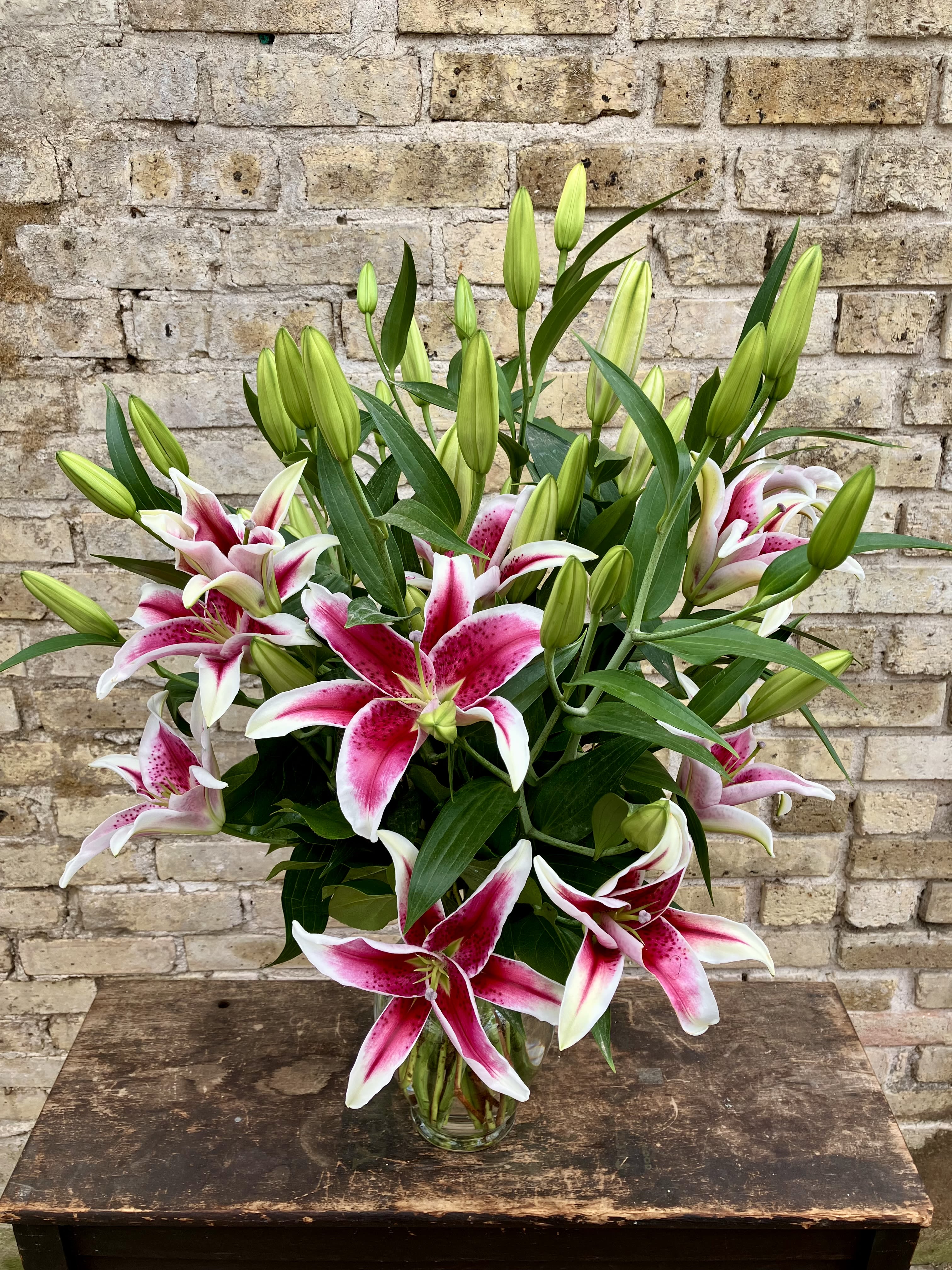 Lovely Lilies - 10 Stems of Pink Lilies Arranged in a Glass Vase. Lily Variety May Vary. Bouquet will be delivered approximately as pictured.