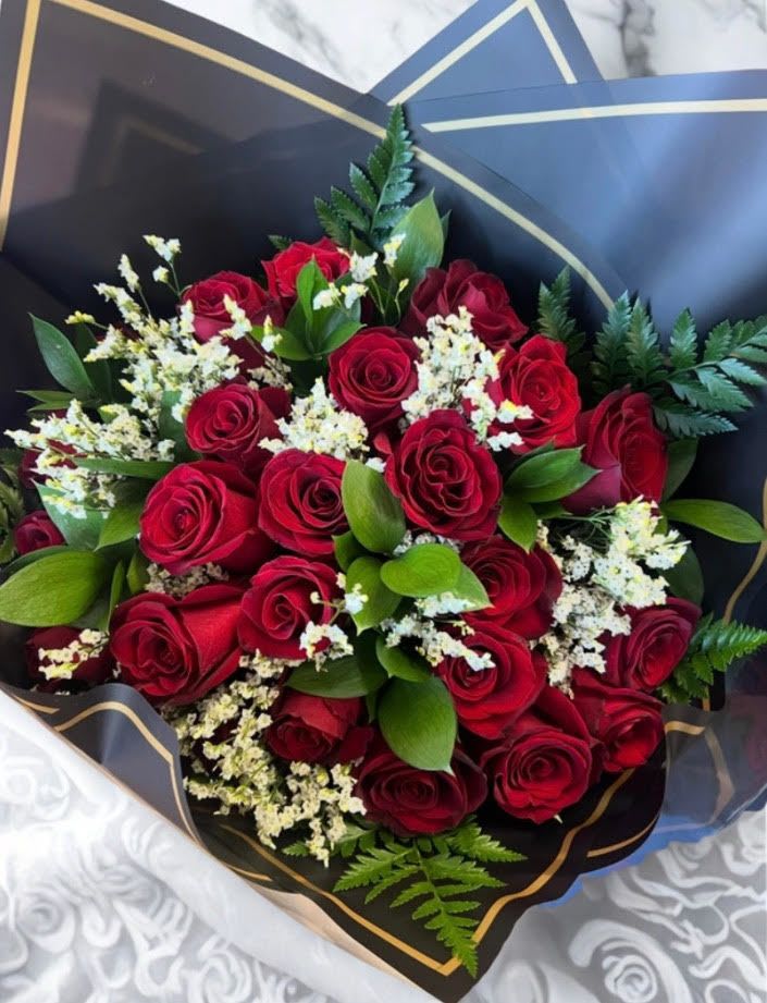 Red Roses Wrapped Bouquet - This Valentine's bouquet Features Red Roses  arranges and elegantly Wrapped to convey timeless love and passion. Perfect gift for Valentine's day   Standard contains 16  roses  every size increased will have an additional 6 roses 