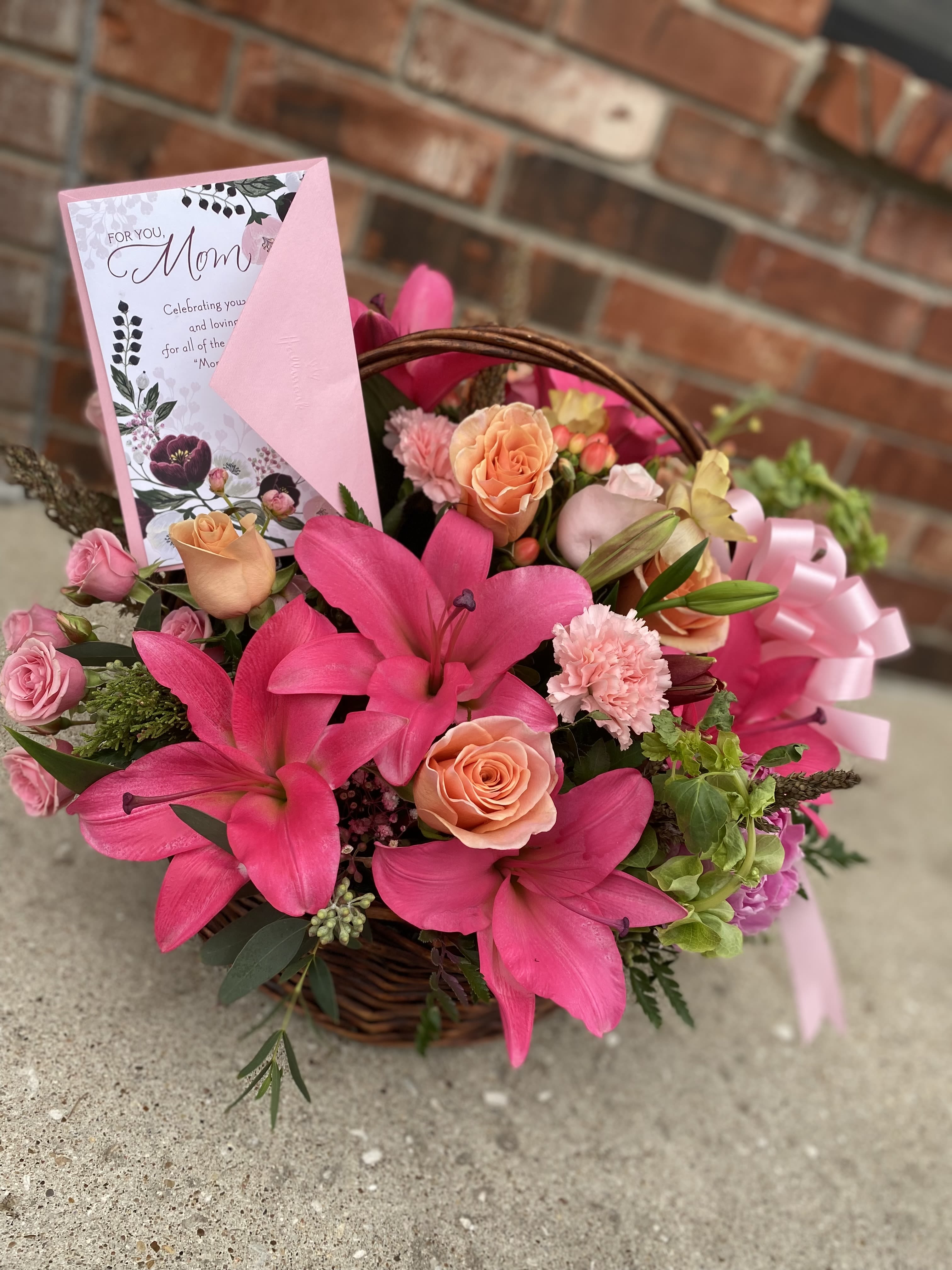 Pink flower basket with lilies, roses, and a Mother's Day card