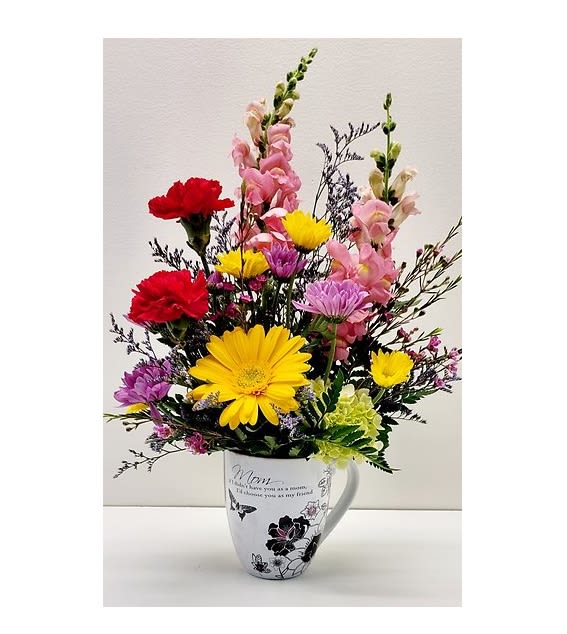 Colorful mixed bouquet in a white mug vase