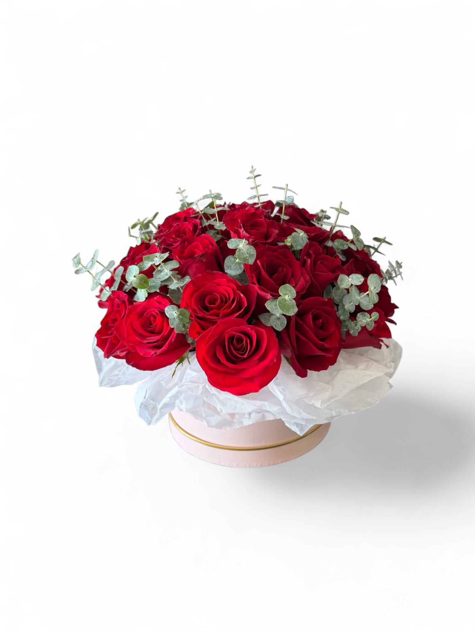 Red rose bouquet in a pink round box with white wrapping