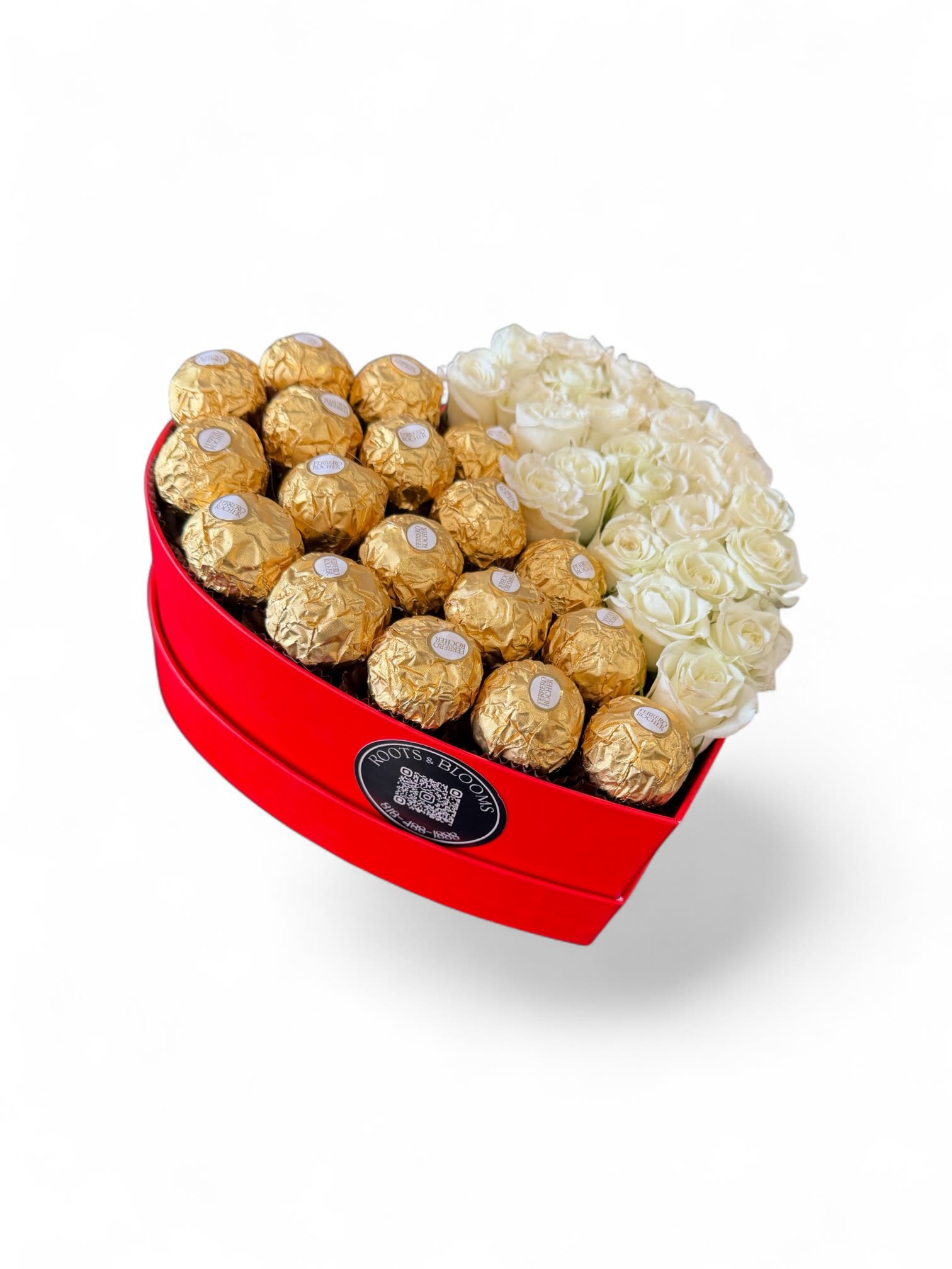 Heart-shaped red box with white roses and gold-wrapped chocolates