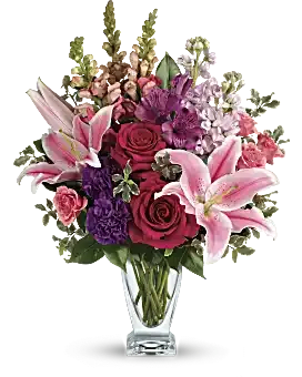 Teleflora's Morning Meadow Bouquet - Hand-delivered in a shapely glass vase, this sumptuous arrangement of roses and lilies is a lavish way to celebrate a special day - or surprise someone just because! Hot pink roses, pink spray roses, pink oriental lilies, purple alstroemeria, purple carnations, light pink stock and pink snapdragons are arranged with pitta negra and camellia leaves. Delivered in a clear Couture vase.SUBSTITUTION POLICY – Always deliver the freshest flowers! Please note the bouquet pictured reflects our original design.  If the exact flowers or container in this arrangement are not available, our local florists will create a beautiful bouquet with the freshest available flowers. 