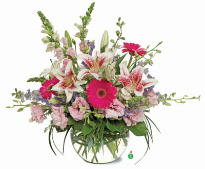 Mixed bouquet with pink gerbera daisies and white lilies in a glass vase