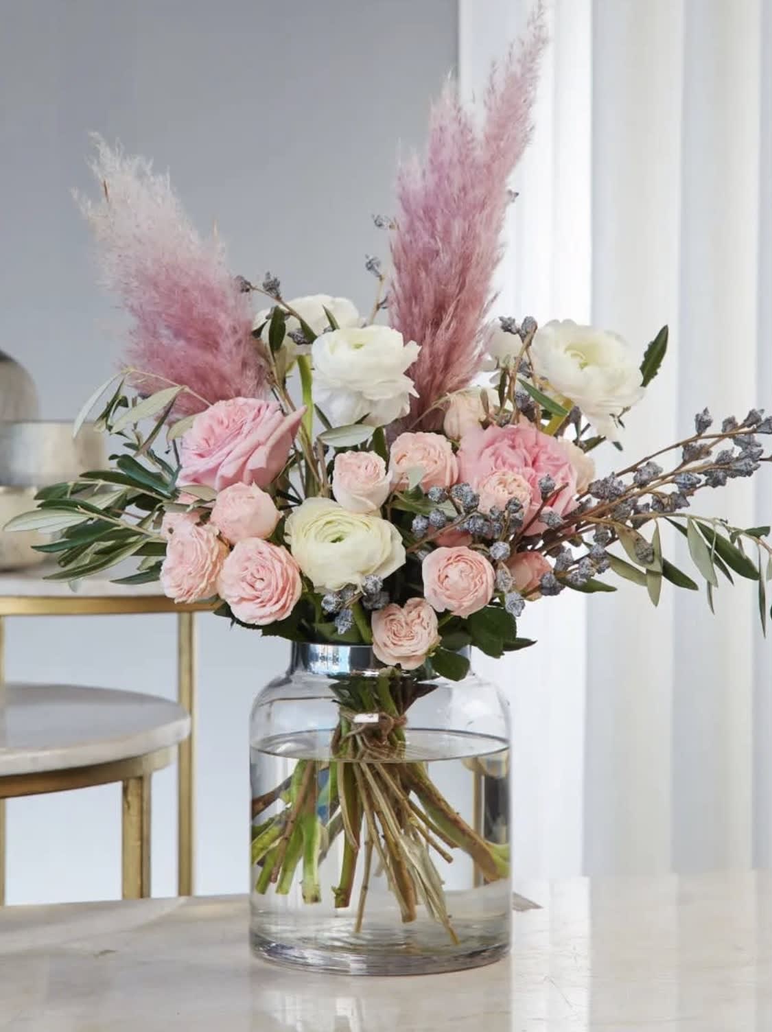 Pink and white floral arrangement in a clear glass vase