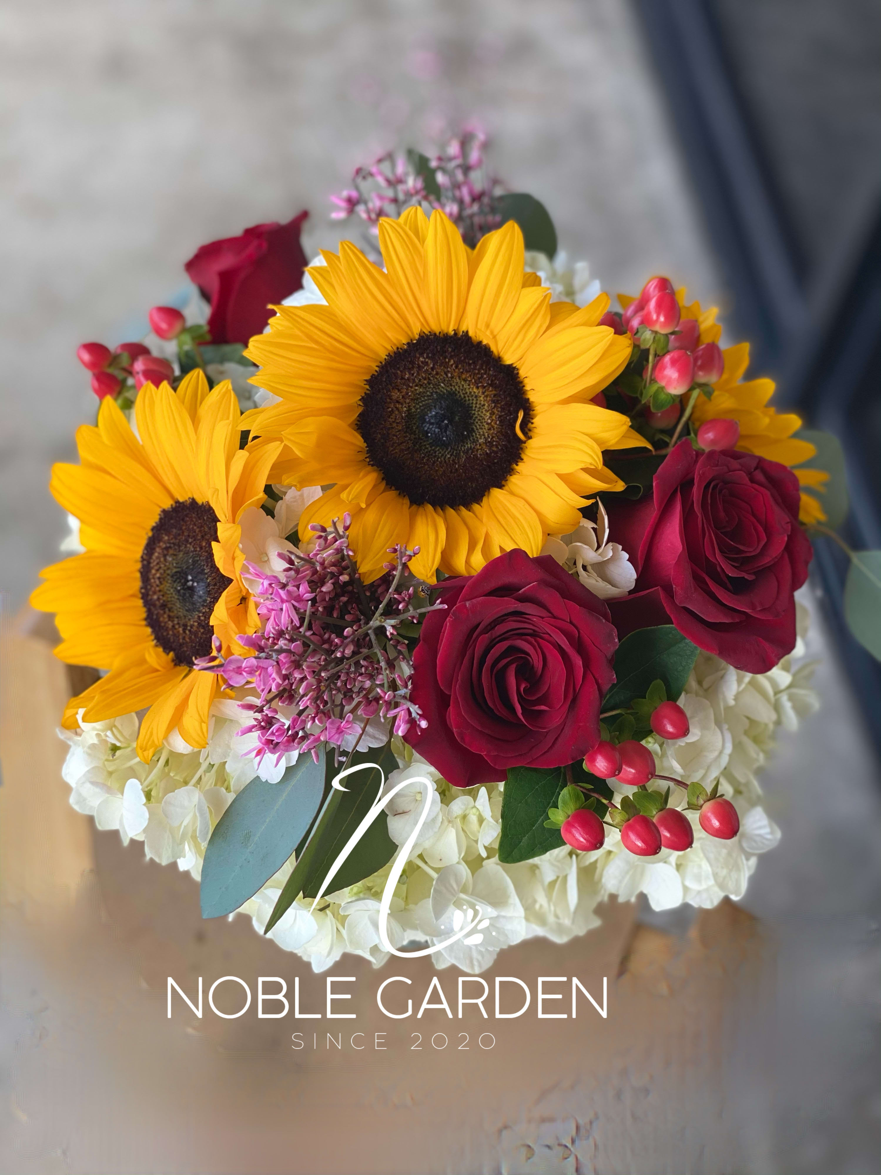 Bouquet of sunflowers, red roses, and white hydrangeas