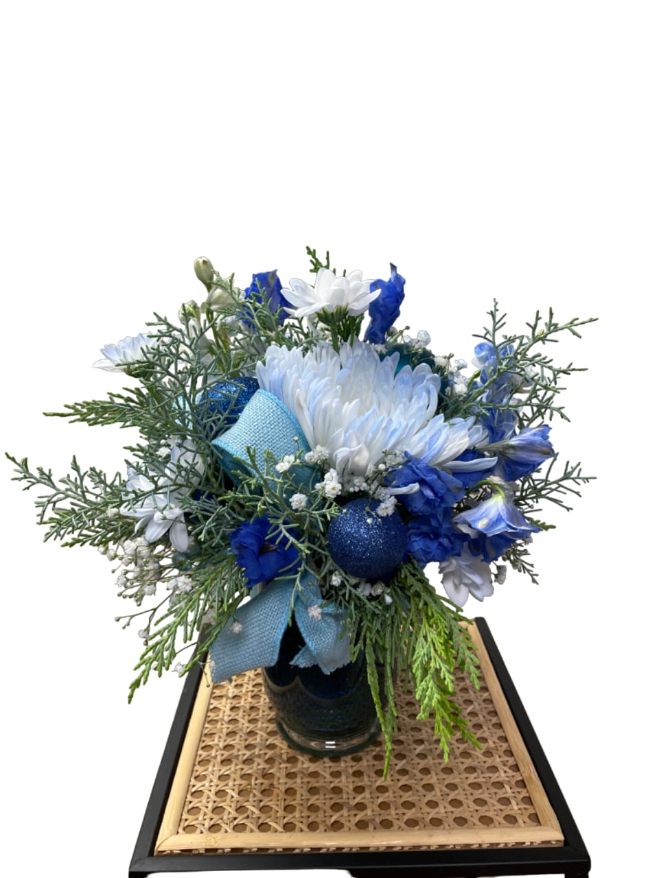 Blue and white bouquet in a glass vase with a ribbon