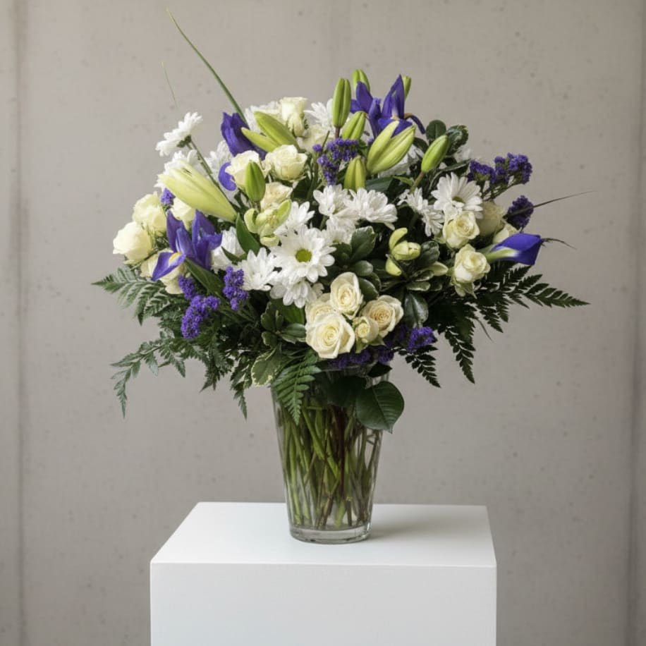 Iris Kissed - Delicate and dreamy, Iris Kissed is a graceful blend of soft whites and rich purples. Featuring striking iris blooms alongside white spray roses, lilies, daisies, and a touch of purple statice, this bouquet is perfect for celebrating sweet moments, offering comfort, or simply sharing a little beauty.