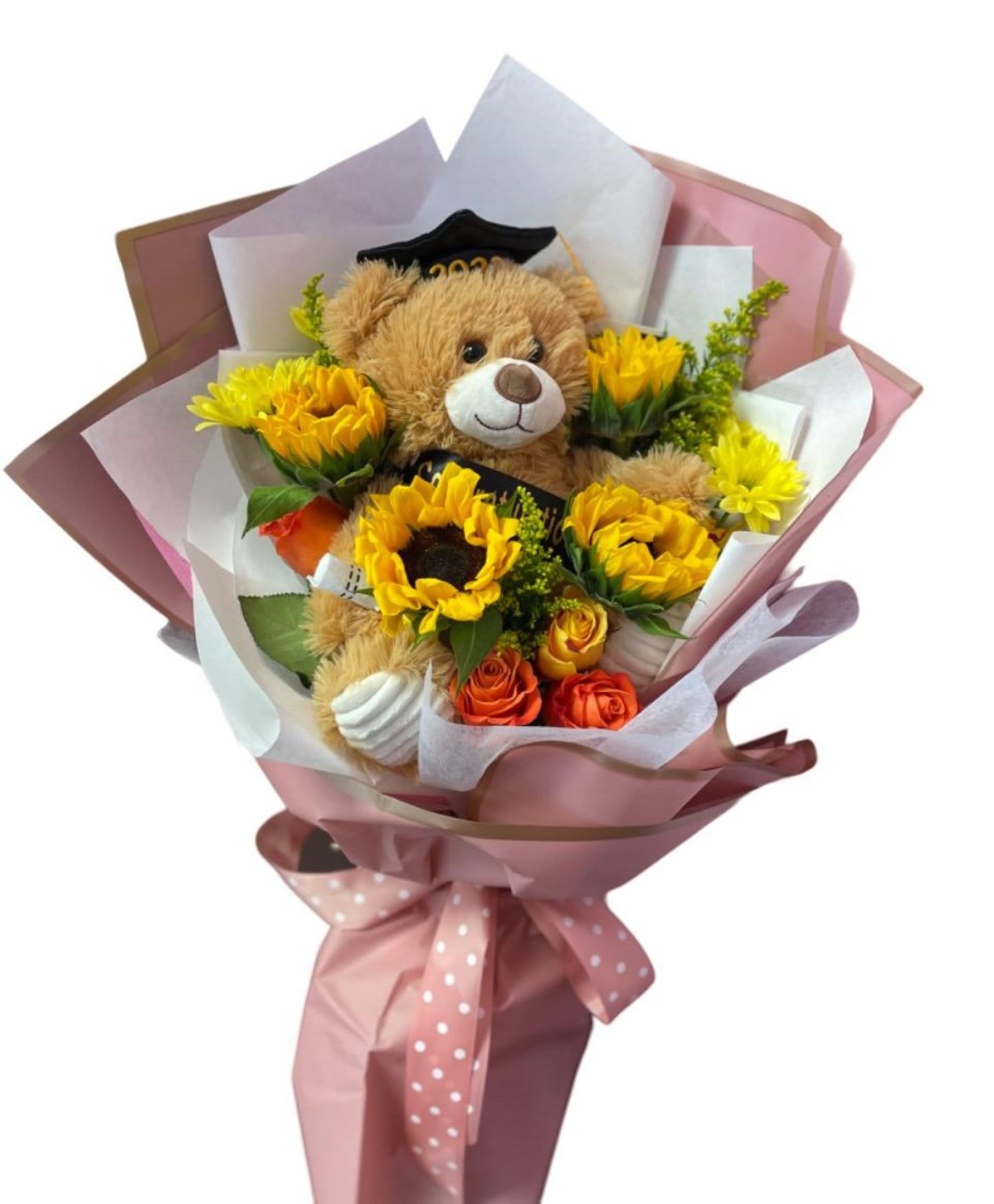 Bouquet with a teddy bear and yellow flowers wrapped in pink paper