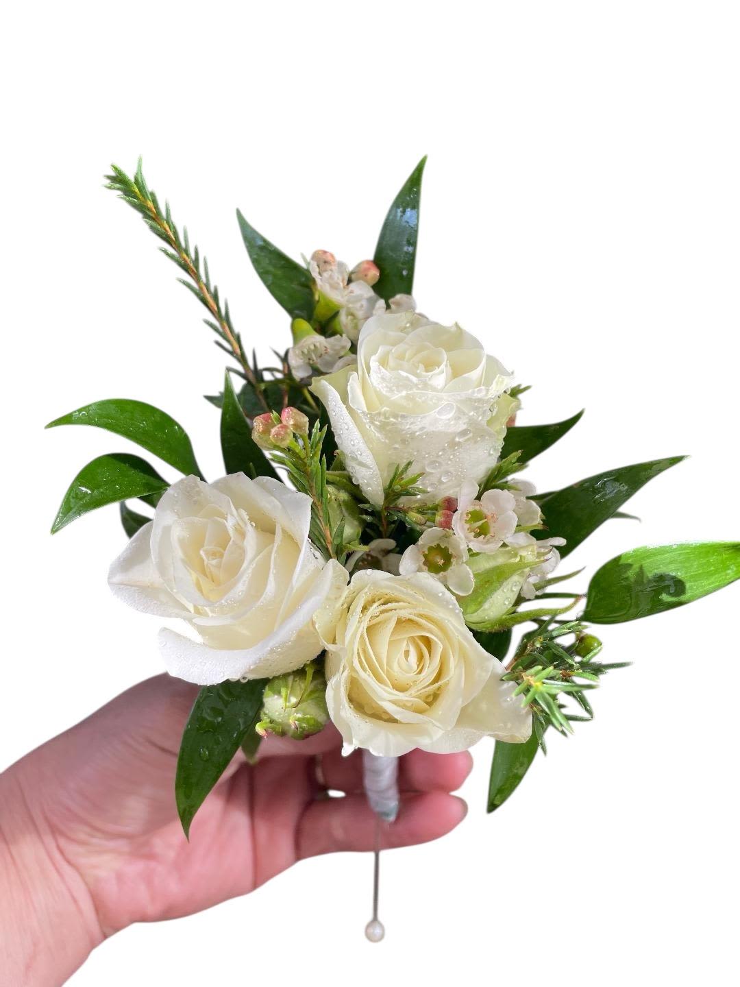White rose boutonniere with small blossoms and glossy leaves
