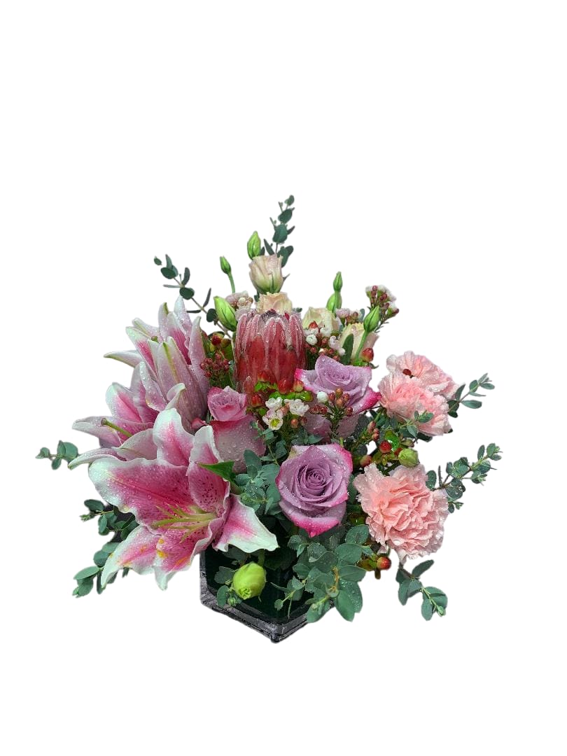 Pink and lavender floral arrangement in a black square vase