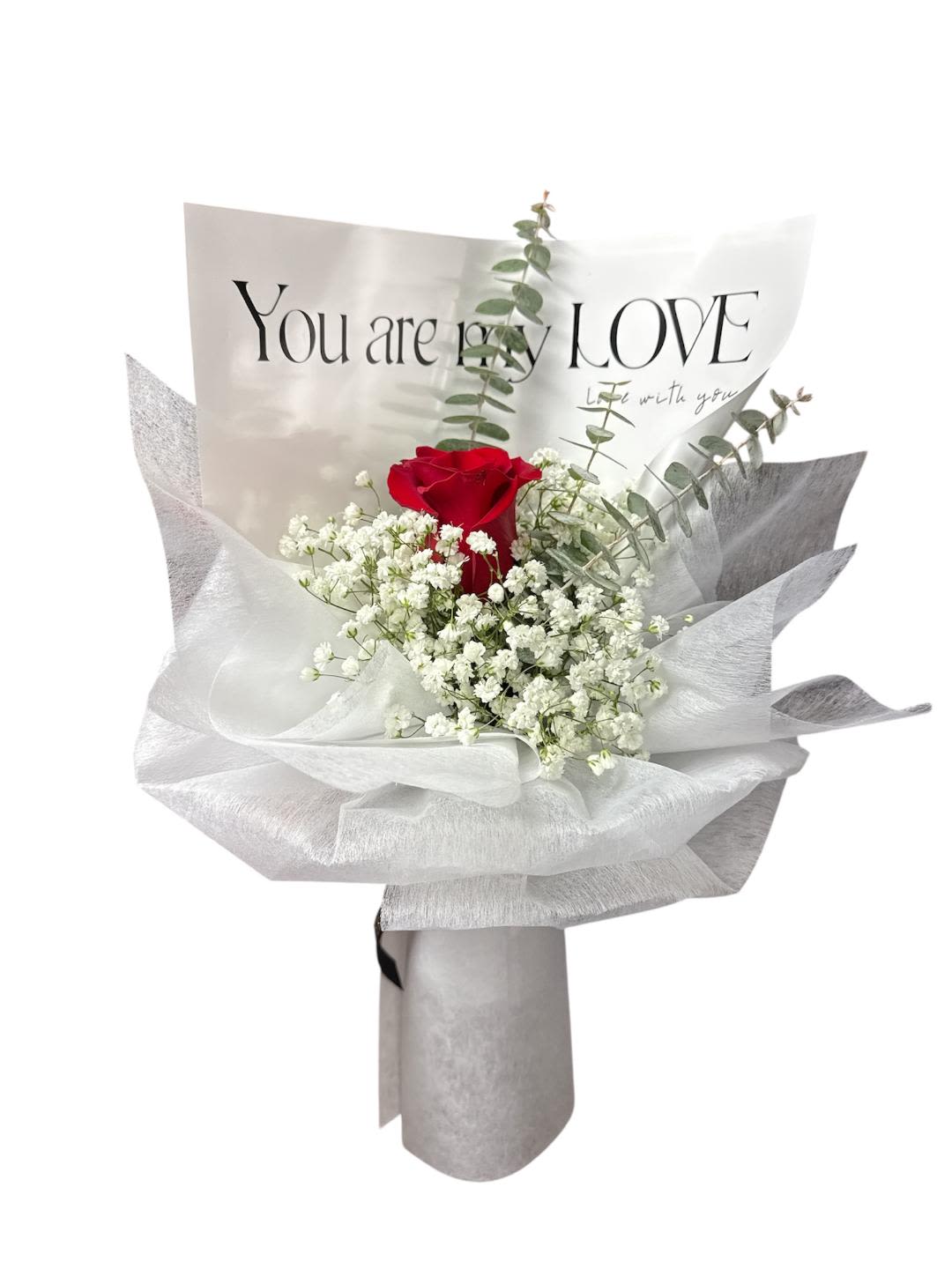 Red rose bouquet with white baby's breath in silver wrapping