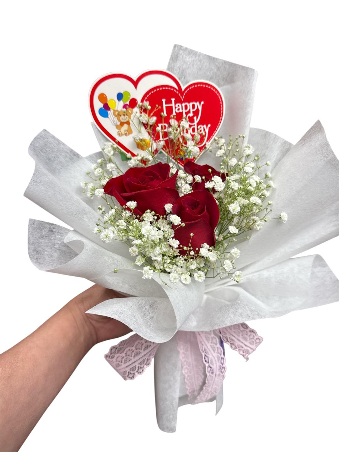Red roses with baby's breath and a Happy Birthday heart topper