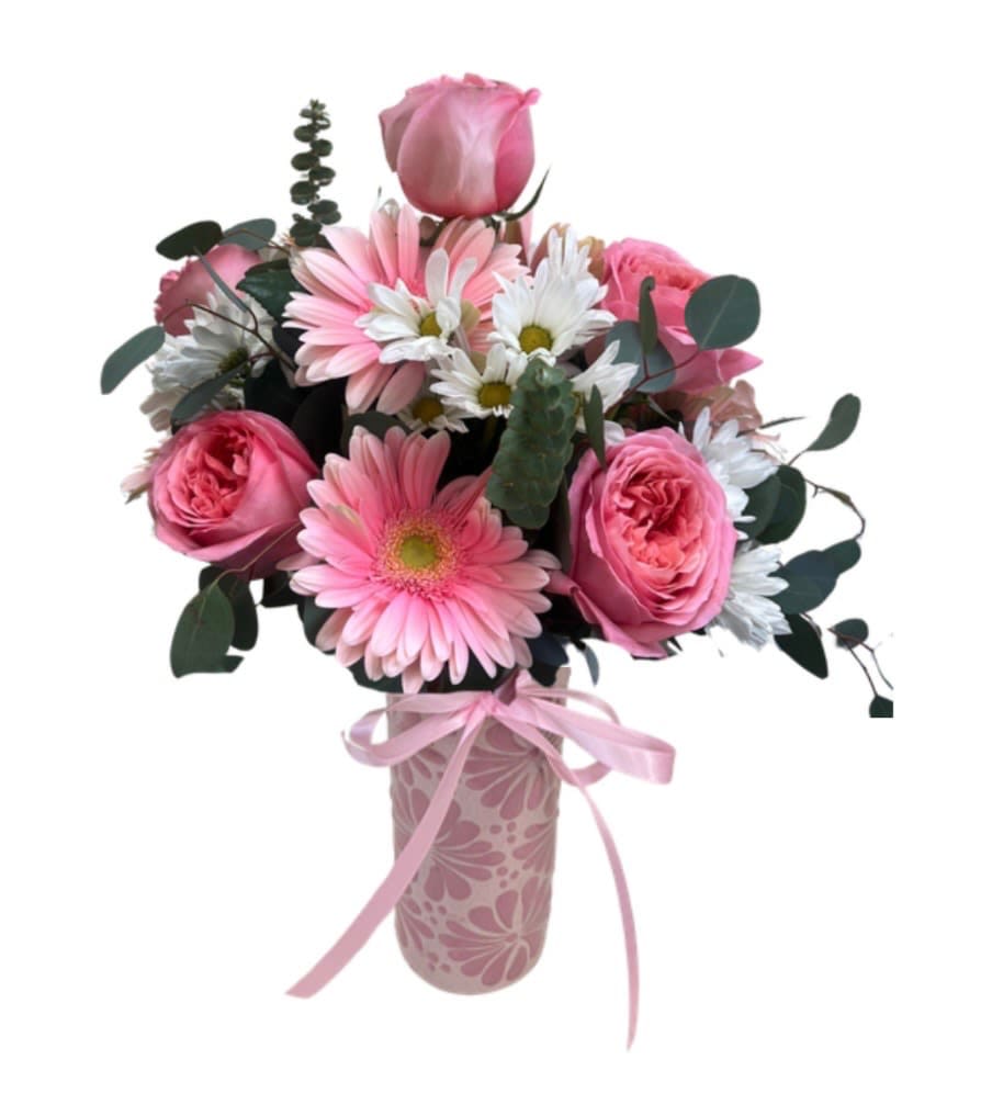 Cielito lindo Cup - Soft pink roses paired with pink gerbera daisies and little white daisies form a compact, rounded bouquet that reads fresh, romantic, and cheerfully feminine - perfect as a Mother's Day gift, birthday surprise, or a "just because" pick-me-up. The arrangement sends a warm, celebratory message so the person you're thinking of will feel seen and cared for. 