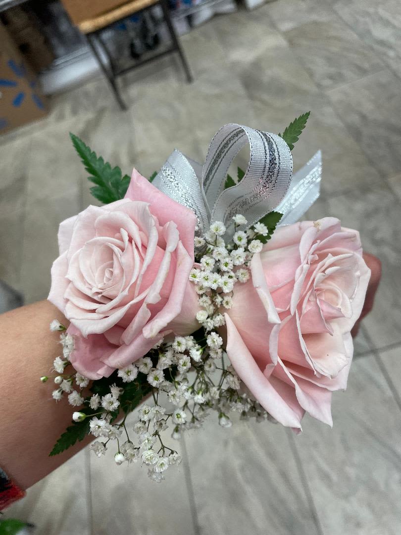 Pink rose corsage with baby's breath and ribbon