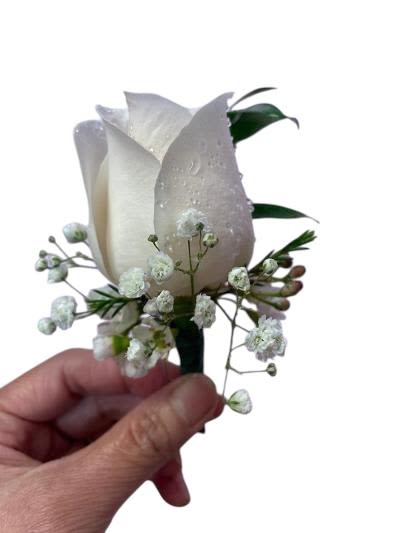 White rose boutonniere with baby's breath and greenery
