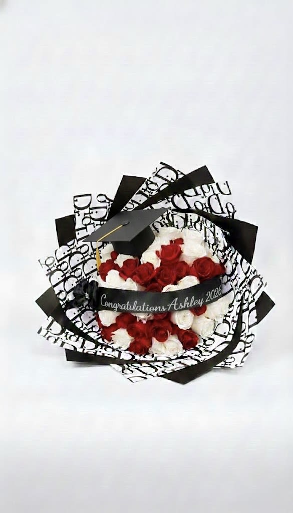 Bouquet of red and white roses with a graduation cap and ribbon