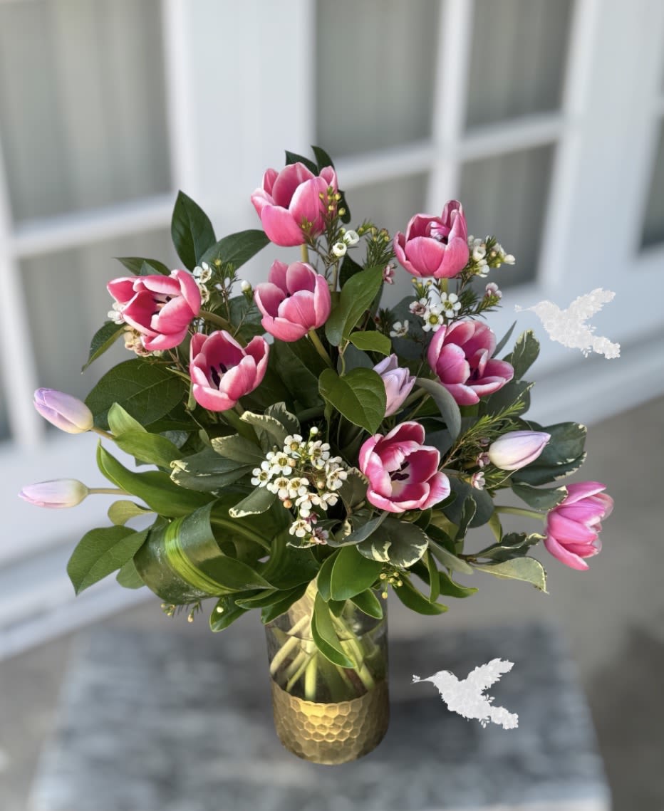 Pink &amp; Lavender Tulips Garden – Mother’s Day Bouquet  - Arrangement measures approximately 13"H This dreamy garden-style bouquet features fresh pink and lavender tulips designed to feel like a walk through a blooming spring garden. Each stem is carefully arranged to create a naturally flowing, airy look that feels luxurious yet heartfelt.  Perfect for the mom who loves soft colors, elegance, and something a little different than traditional roses.  Artfully arranged alongside delicate white accent florals and lush greenery, creating a natural, garden-inspired design that feels fresh and refined, styled in a modern glass vase.  Perfect for: Mother’s Day Birthdays Just because Daughters sending love from afar Husbands upgrading from “last-minute flowers” Coastal luxury gifting in Orange County   Delivery Details: Available for delivery in Fullerton, Newport Beach, Laguna Beach &amp; surrounding OC areas Mother’s Day orders are limited — pre-order now to secure your delivery date Limited Mother’s Day availability – tulips are seasonal and sell out quickly.