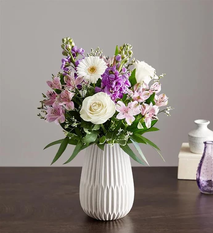 Treasured Memories Lavender &amp; White - Soft lavender stock and crisp white roses mingle with lavender alstroemeria in a garden-style bouquet made for birthdays, thank-you gestures, or gentle spring celebrations. This flower arrangement puts the recipient first: the layered pastels and bursts of purple create a calming, cheerful impression that will make them feel noticed and truly celebrated.