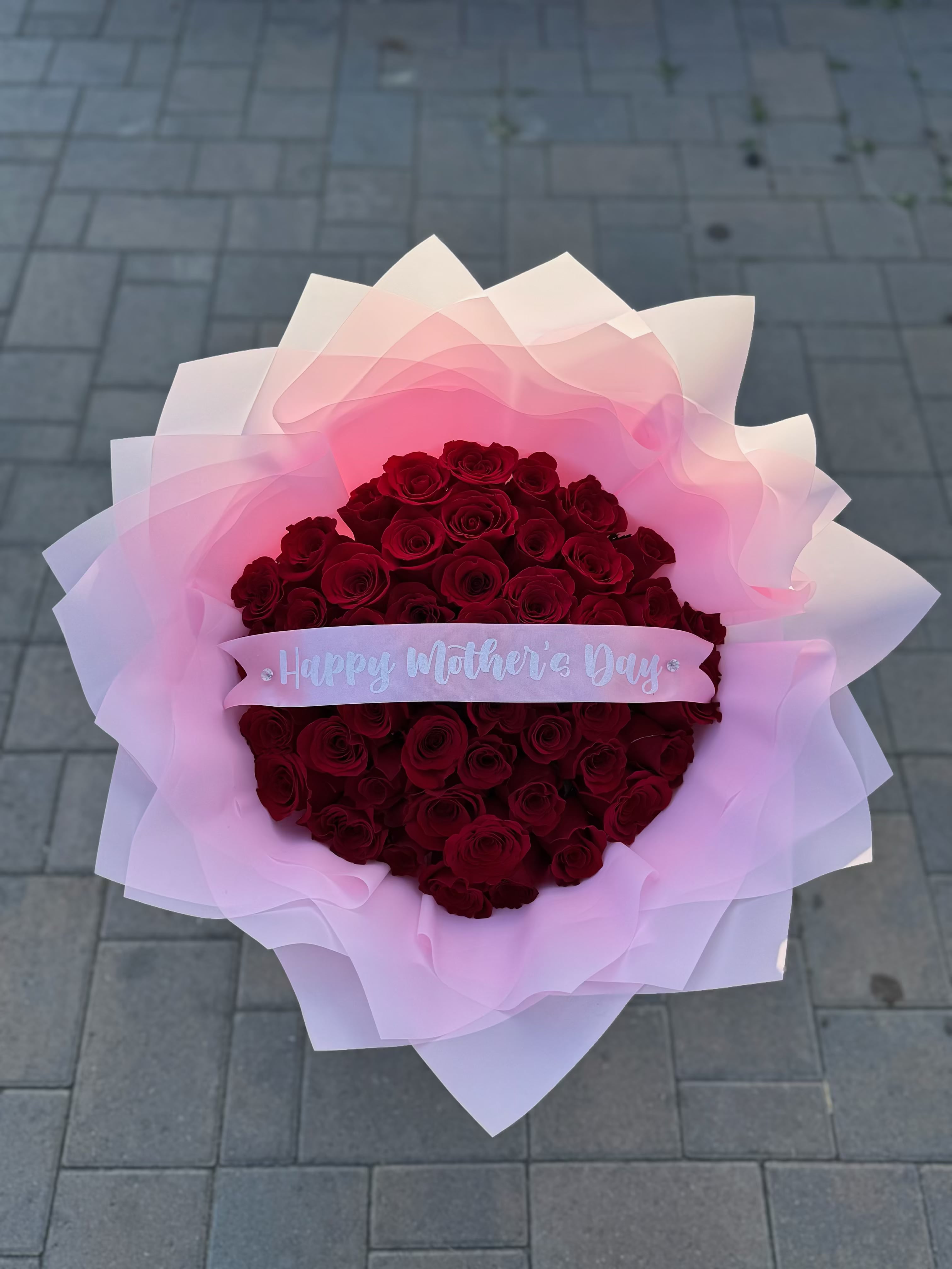 Mother's Day Ramo Buchon - Red Roses with your choice of wrapper color and Happy Mother's Day Ribbon Included  Please provide wrapper color choice and whether you'd like the ribbon in English or Spanish, in the notes at checkout or please call us. 