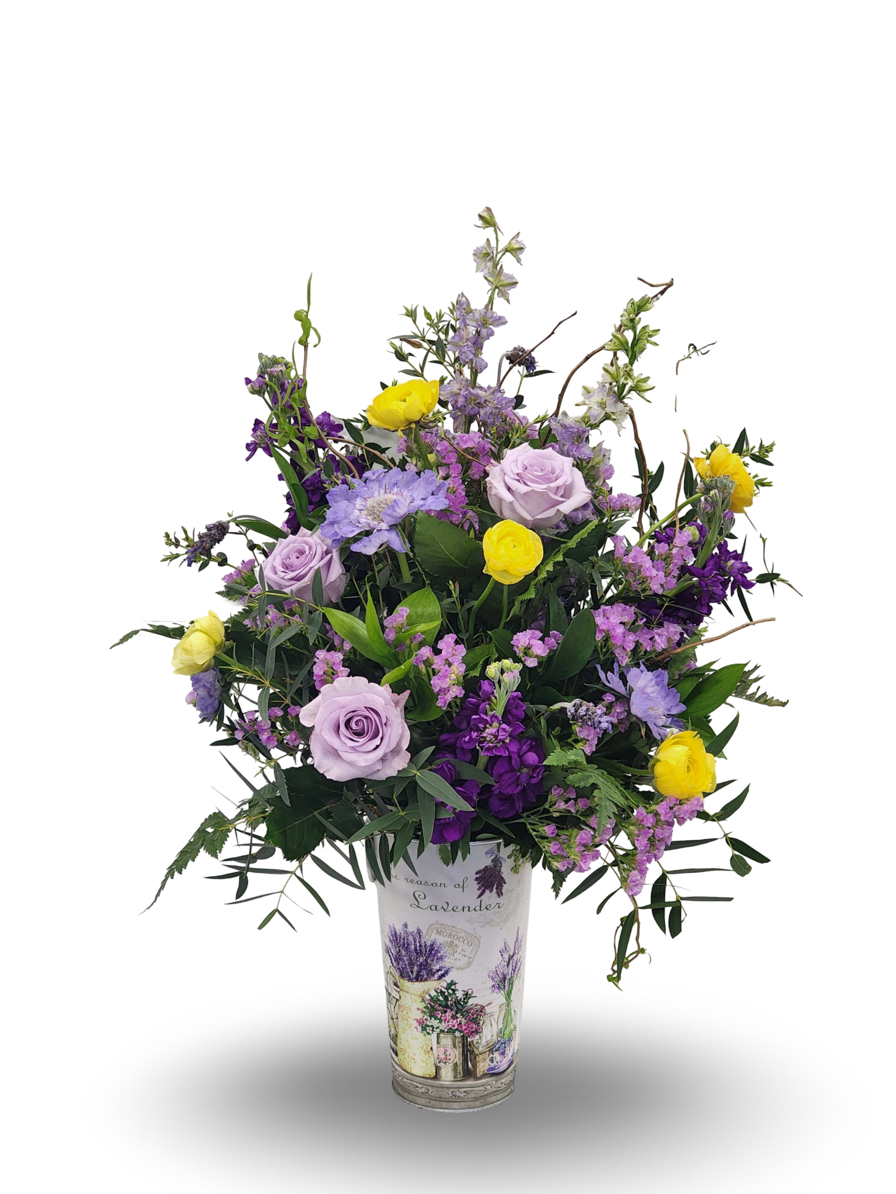 Lavender and yellow flower arrangement in a decorative vase