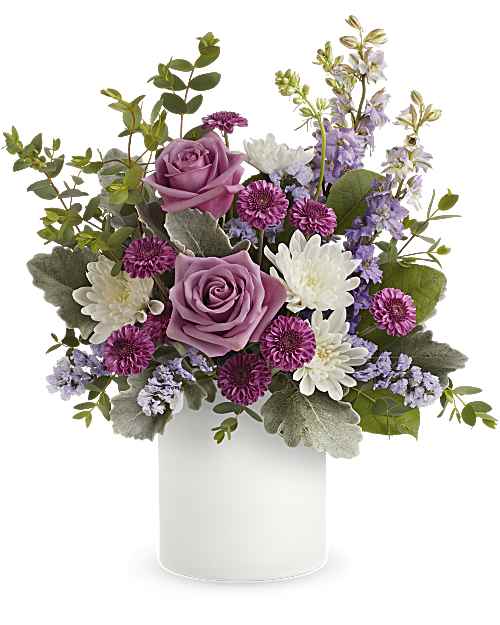 Playfully Yours - Lavender roses sit gently above white daisy-like blooms in a garden-style bouquet designed for spring celebrations, birthdays, or a thoughtful thank-you - a soft, feminine choice for a birthday bouquet or everyday gifting. Playfully Yours is the kind of arrangement that makes the person you're thinking of feel noticed and soothed: delicate color contrasts and an airy silhouette read as both celebratory and quietly personal.